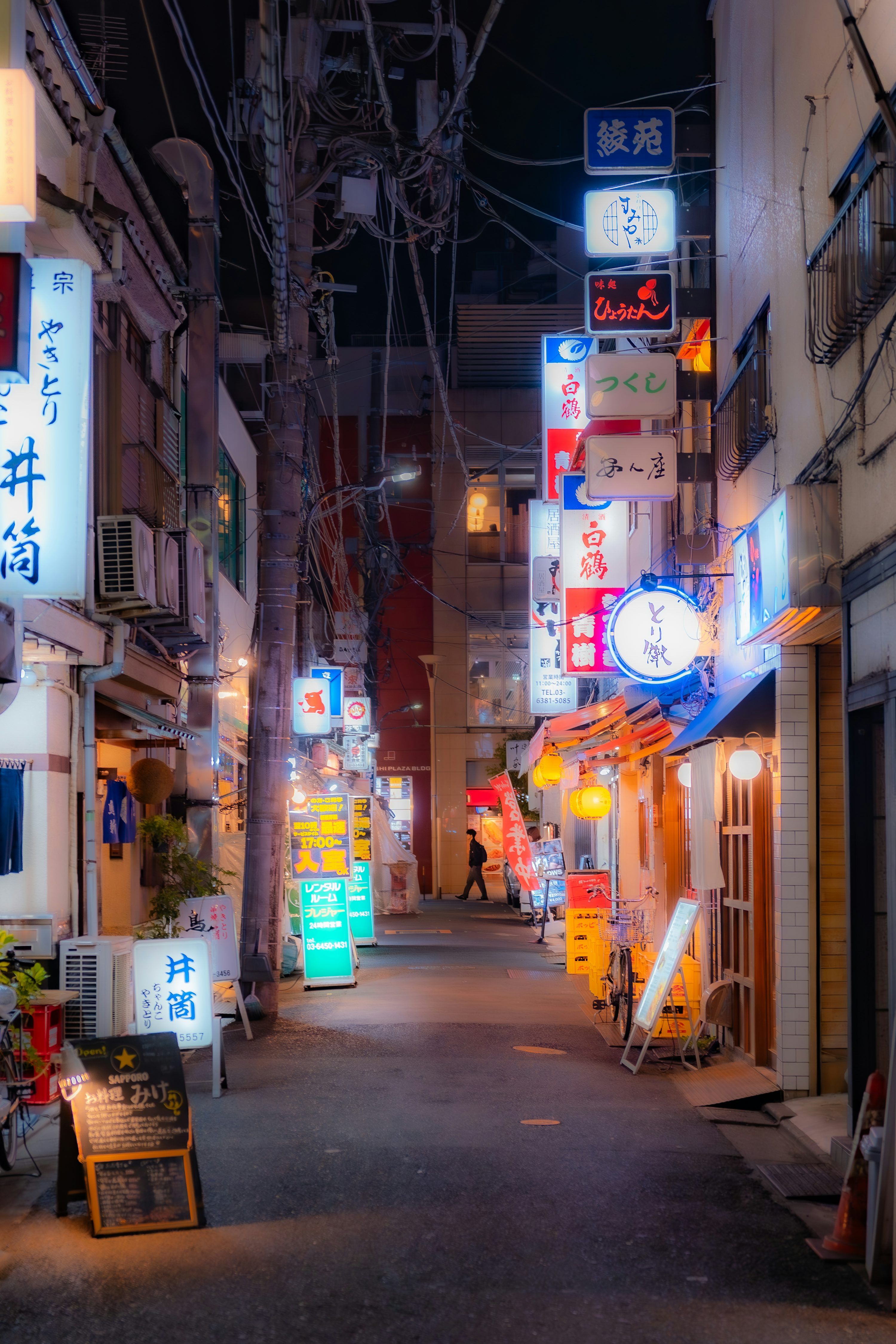 3000x4500 A narrow alleyway in a japanese city at night. photo