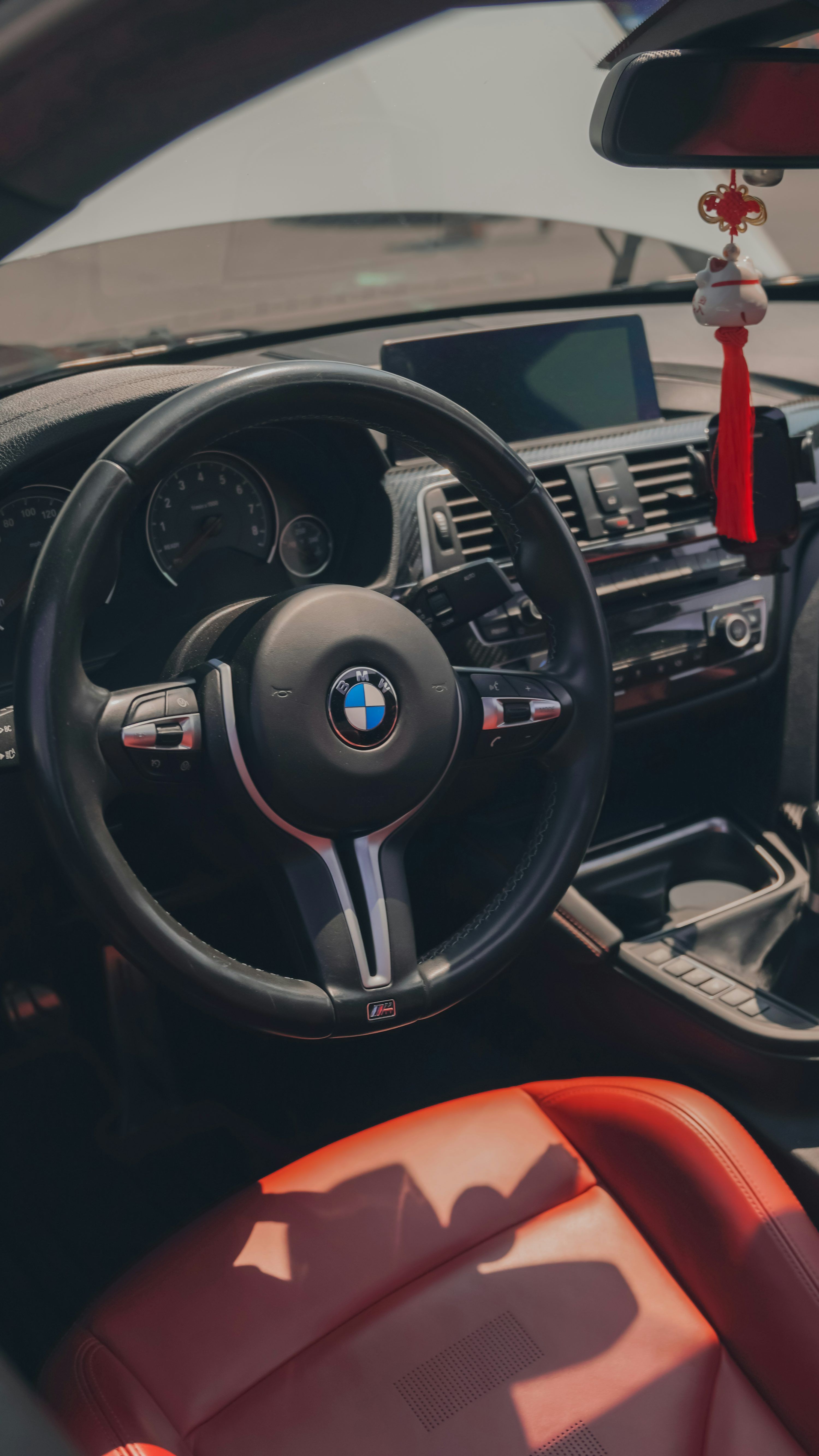3000x5332 The interior of a car with a steering wheel and dashboard photo