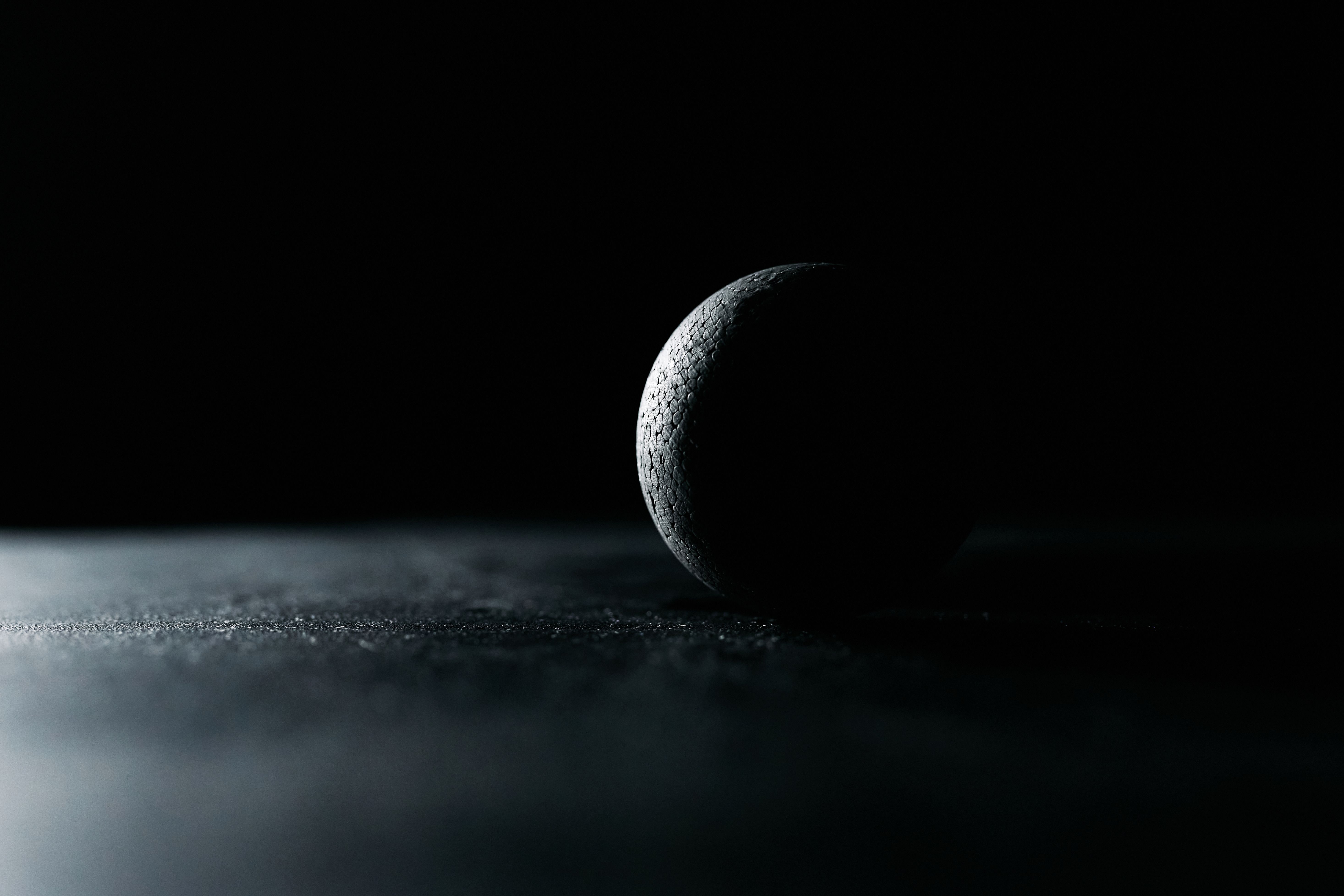 5864x3910 A Black Ball on Black Surface · Free