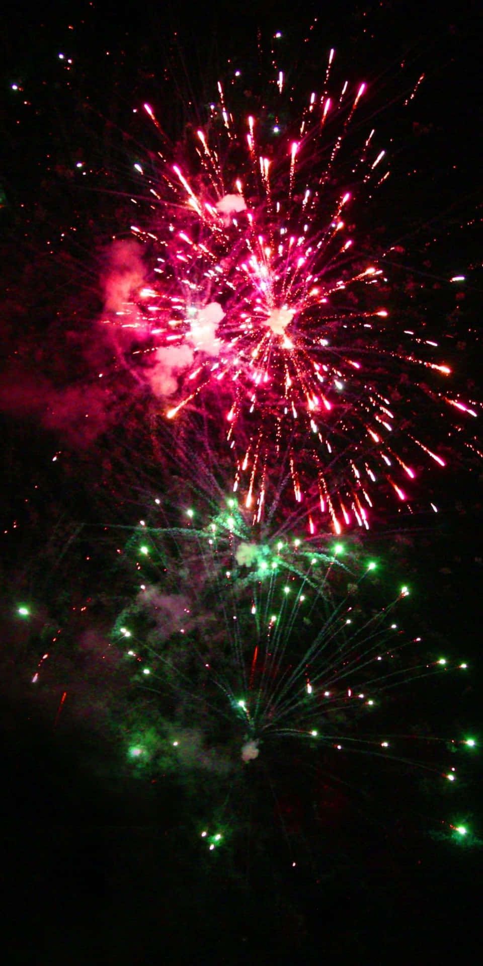 960x1920 Download Sparkly Pink And Green Fireworks Background