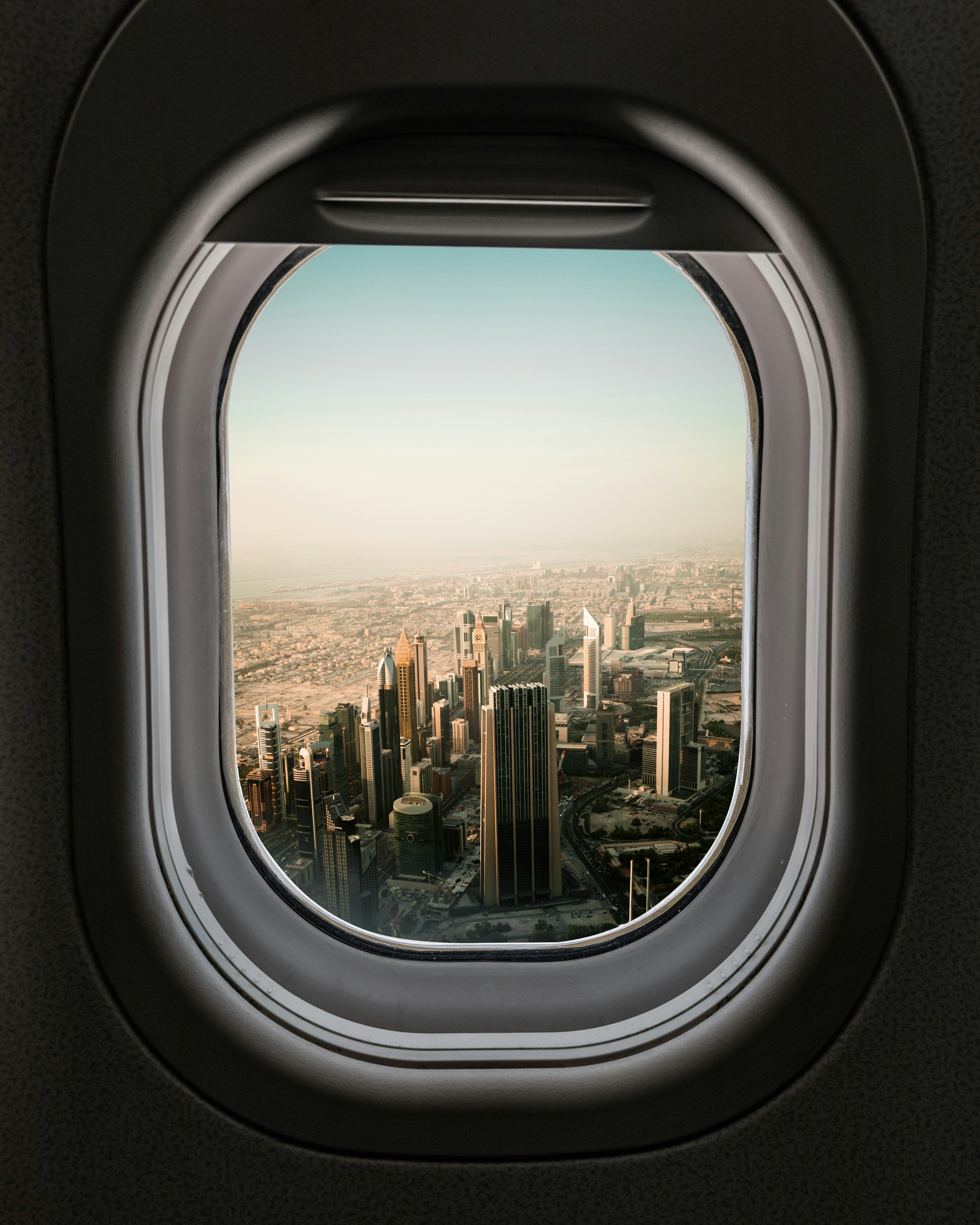 3000x3750 Airplane window view of city during daytime photo