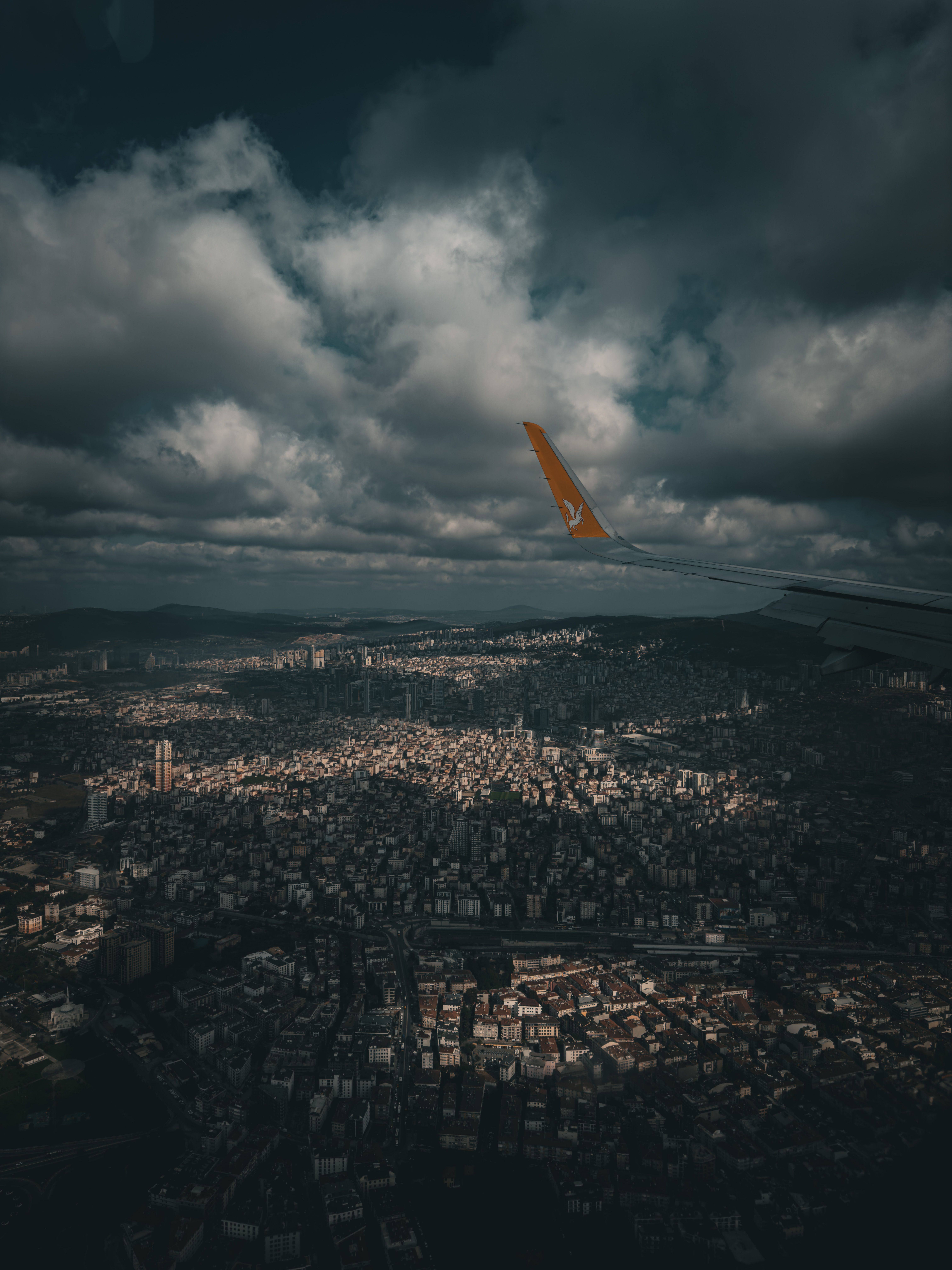 6048x8064 Airplane Wing over City under Clouds · Free