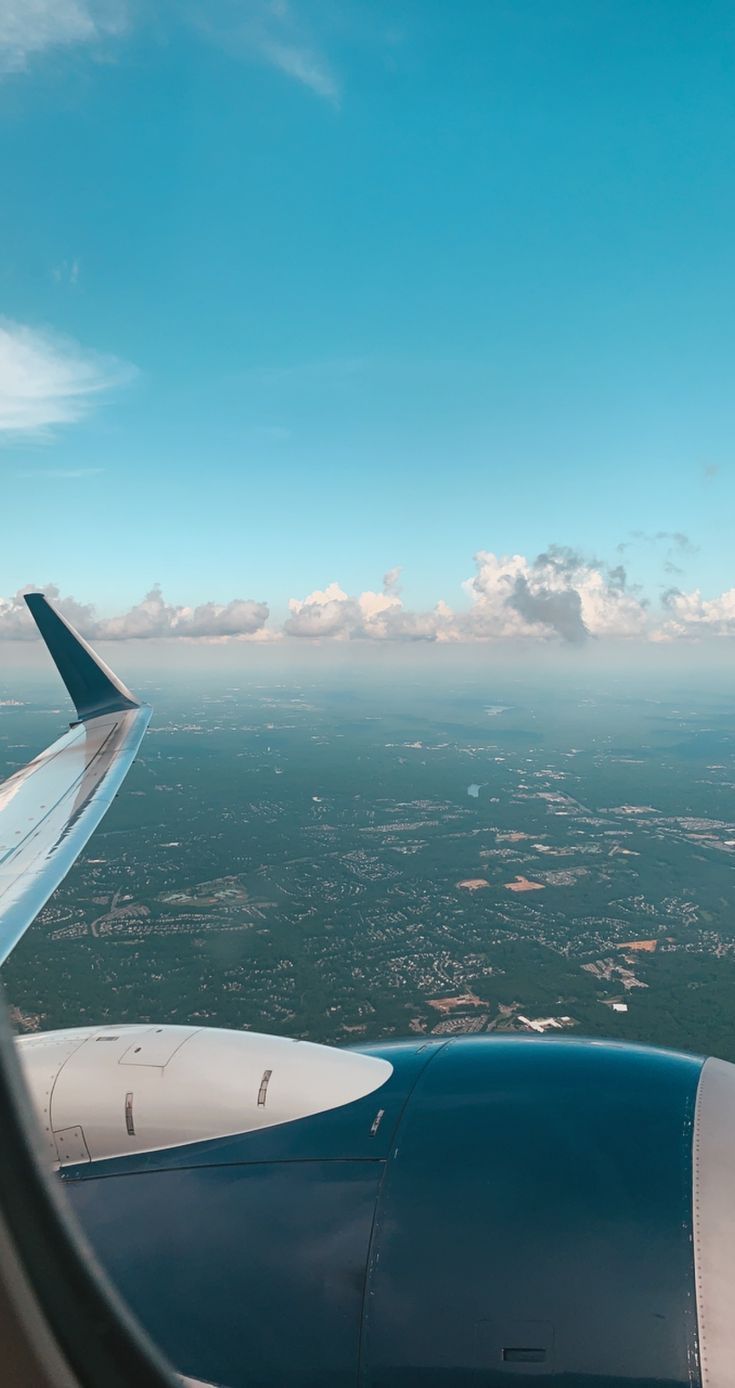735x1388 a clear day in the sky with minimal clouds from an airplane window