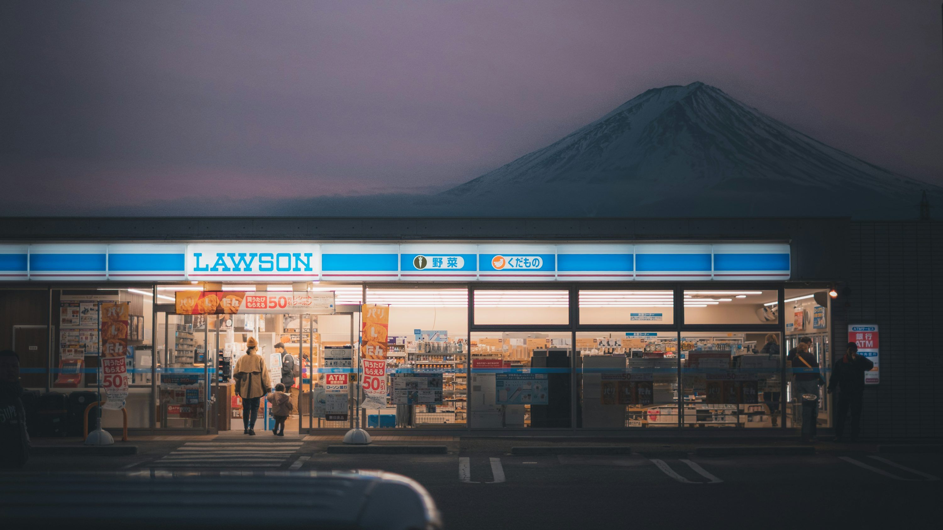 3000x1688 A store front with a mountain in the background photo