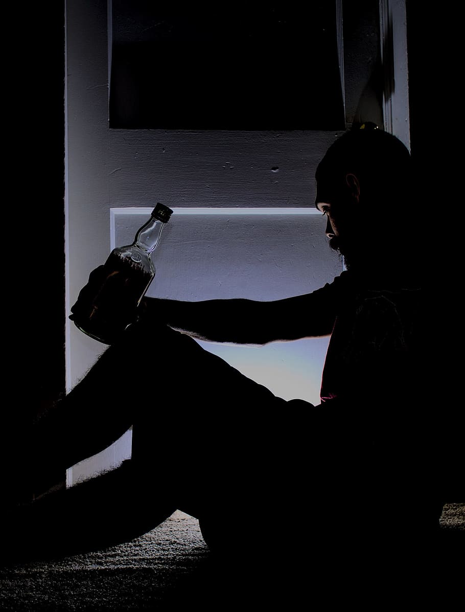 910x1199 man, sitting, next, door, holding, bottle, liquor, drinking