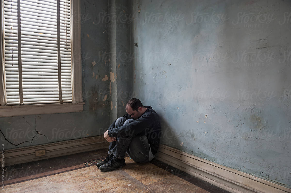 1200x798 Depressed Man Sitting In Abandoned Room by Stocksy Contributor CWP, LLC
