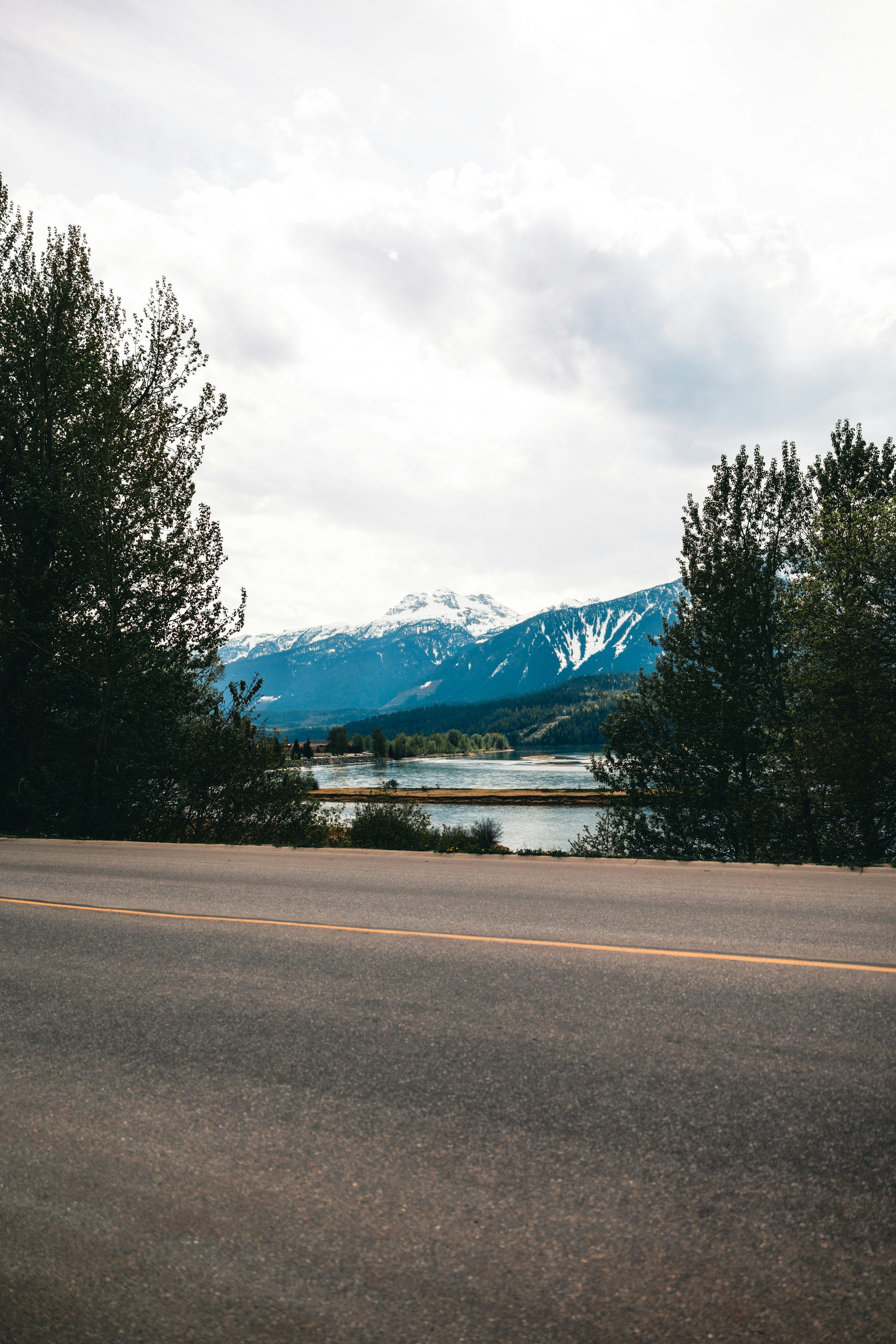 3000x4498 A view of a road with mountains in the background photo