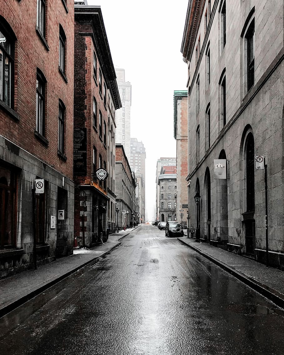 910x1138 person, standing, beside, car, buildings, narrow, road, building