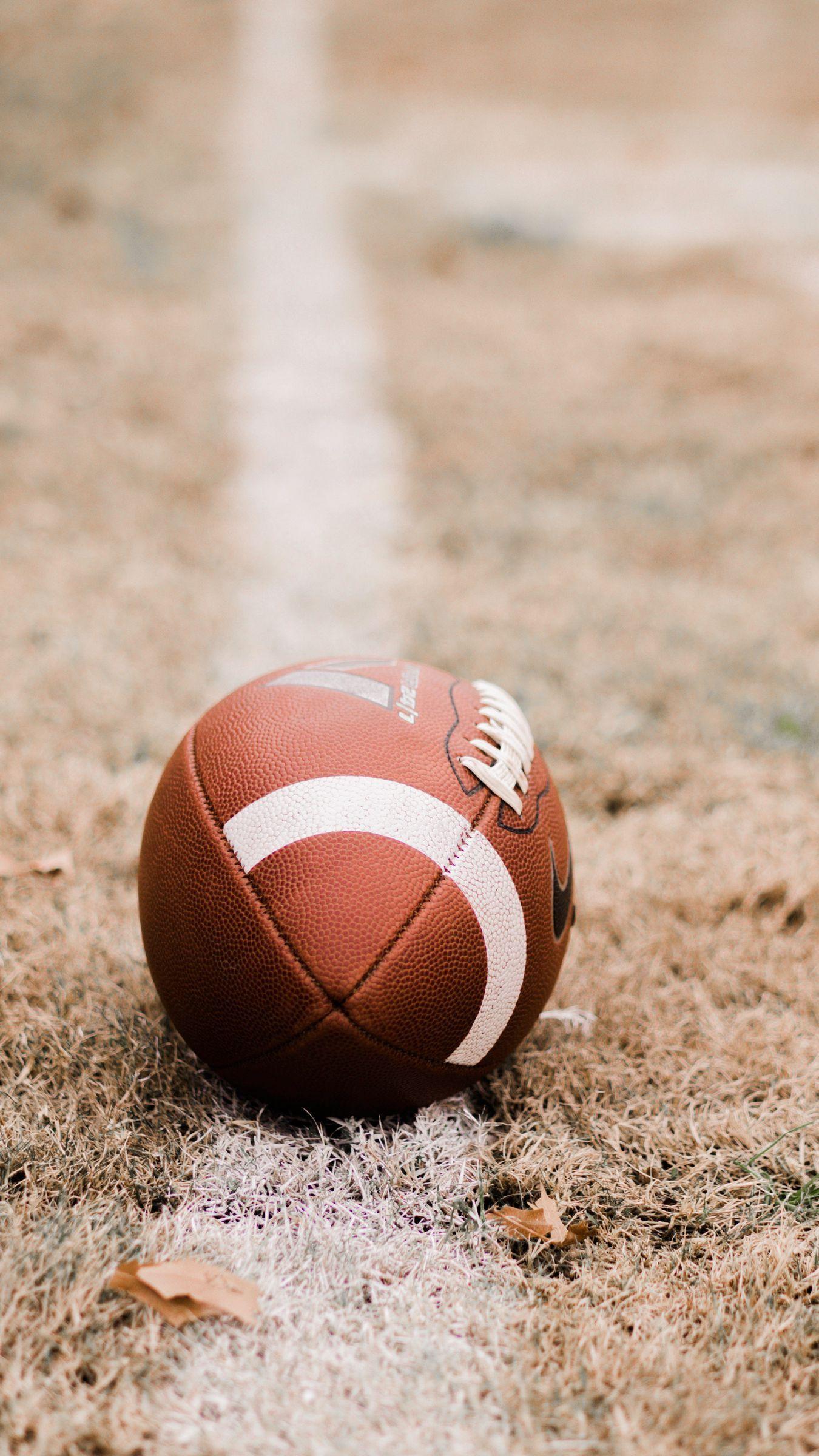 1350x2400 Download wallpaper 1350x2400 american football, ball, lawn