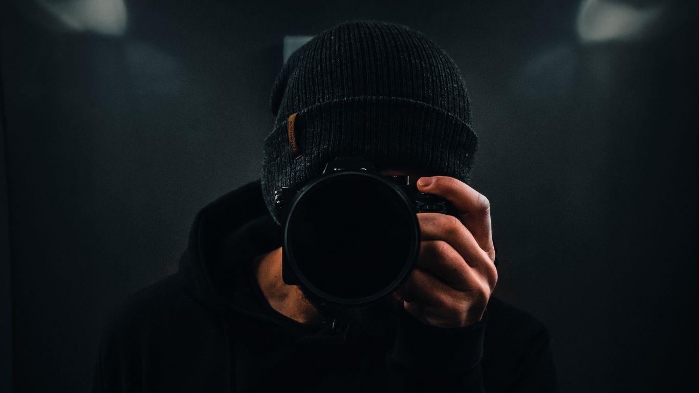 1366x768 Download wallpaper 1366x768 photographer, camera, dark, black
