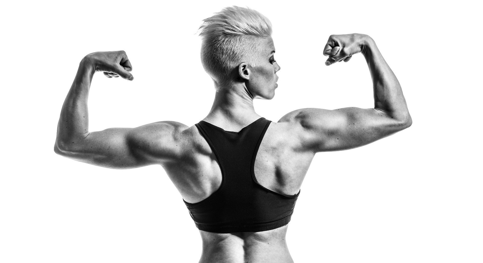 1980x1080 women, fitness model, model, short hair, women indoors, back, muscles, monochrome, sports bra, muscular, white background, simple background, indoors, studiox1080 Wallpaper