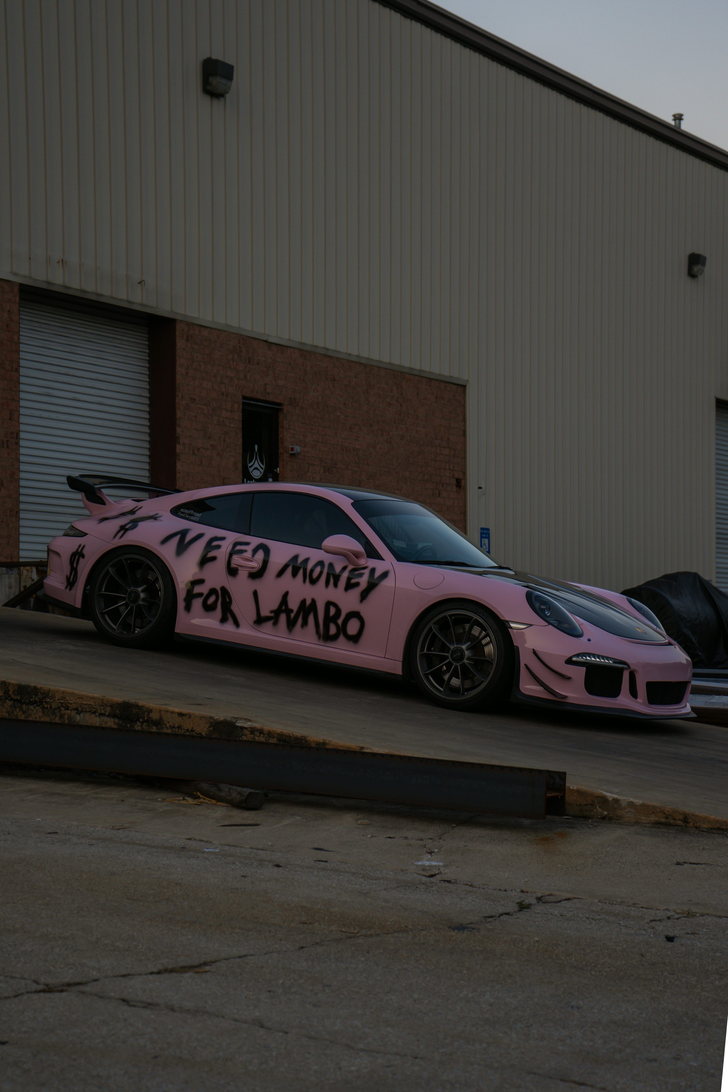 3000x4500 Pink porsche with graffiti saying need money for lambo photo