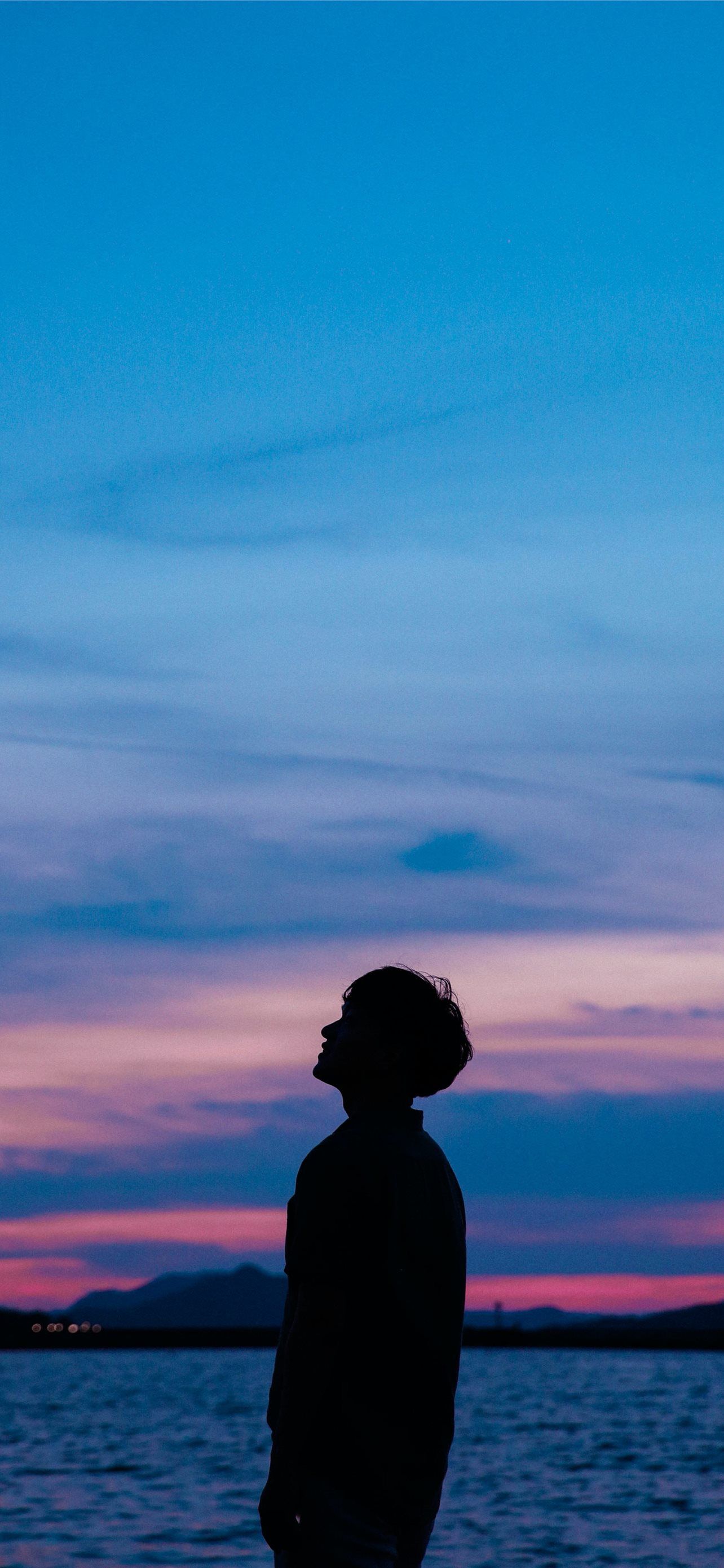 1284x2778 man standing near beach iPhone Wallpaper Free Download