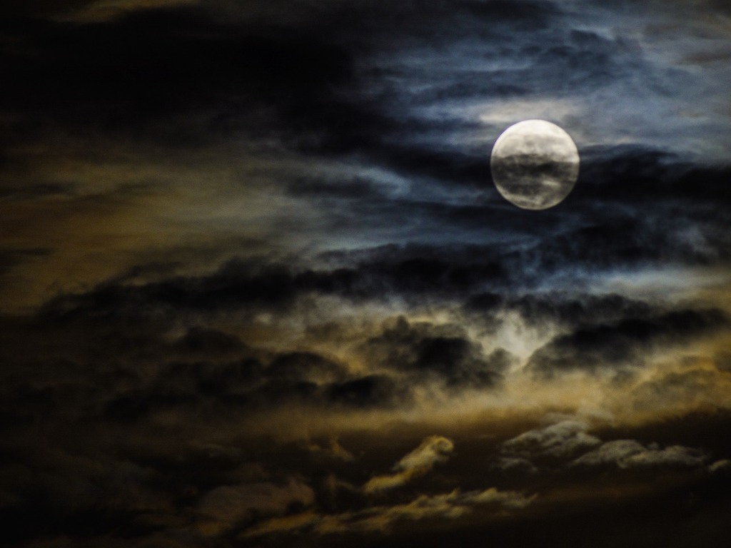 1024x768 A full moon is seenuds. Blue moon cloudy