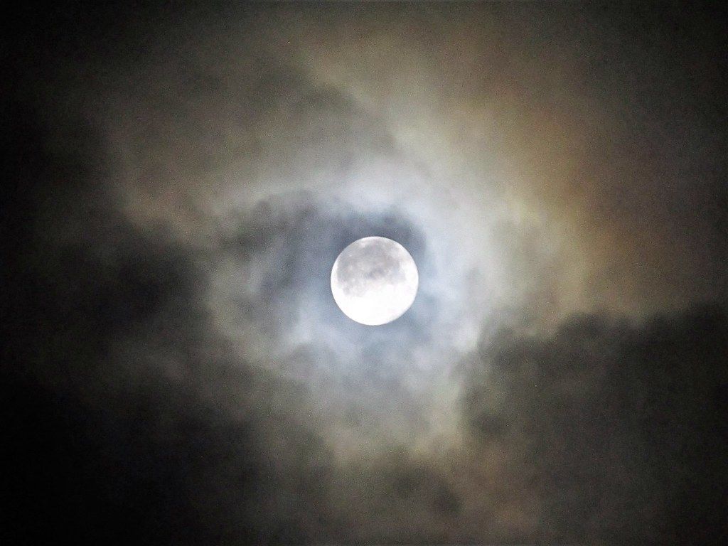 1024x768 Cloudy Moon Shot. The Moon behind some thin Cloud making th
