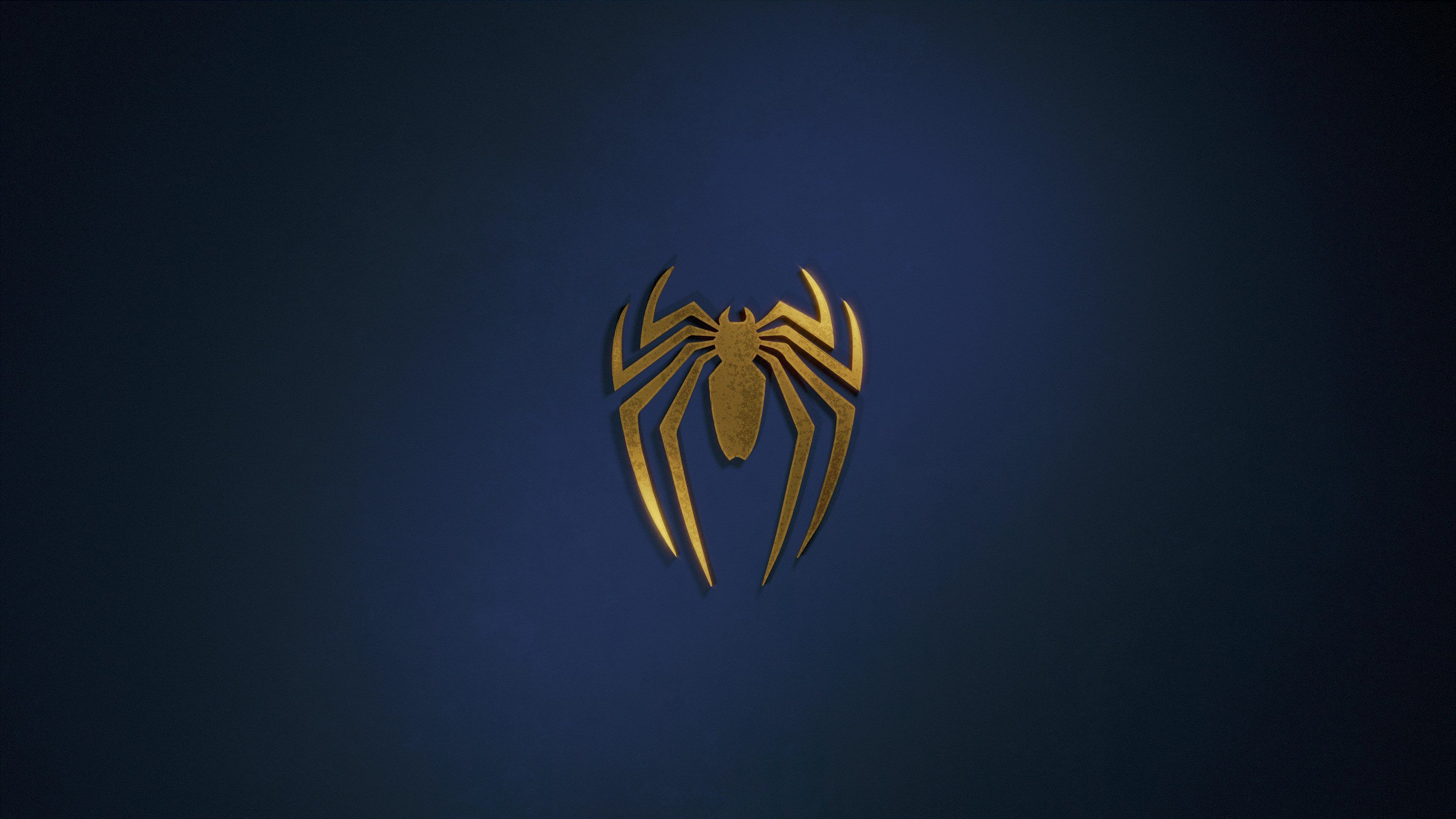 3000x1688 A golden spider logo on a dark blue background photo