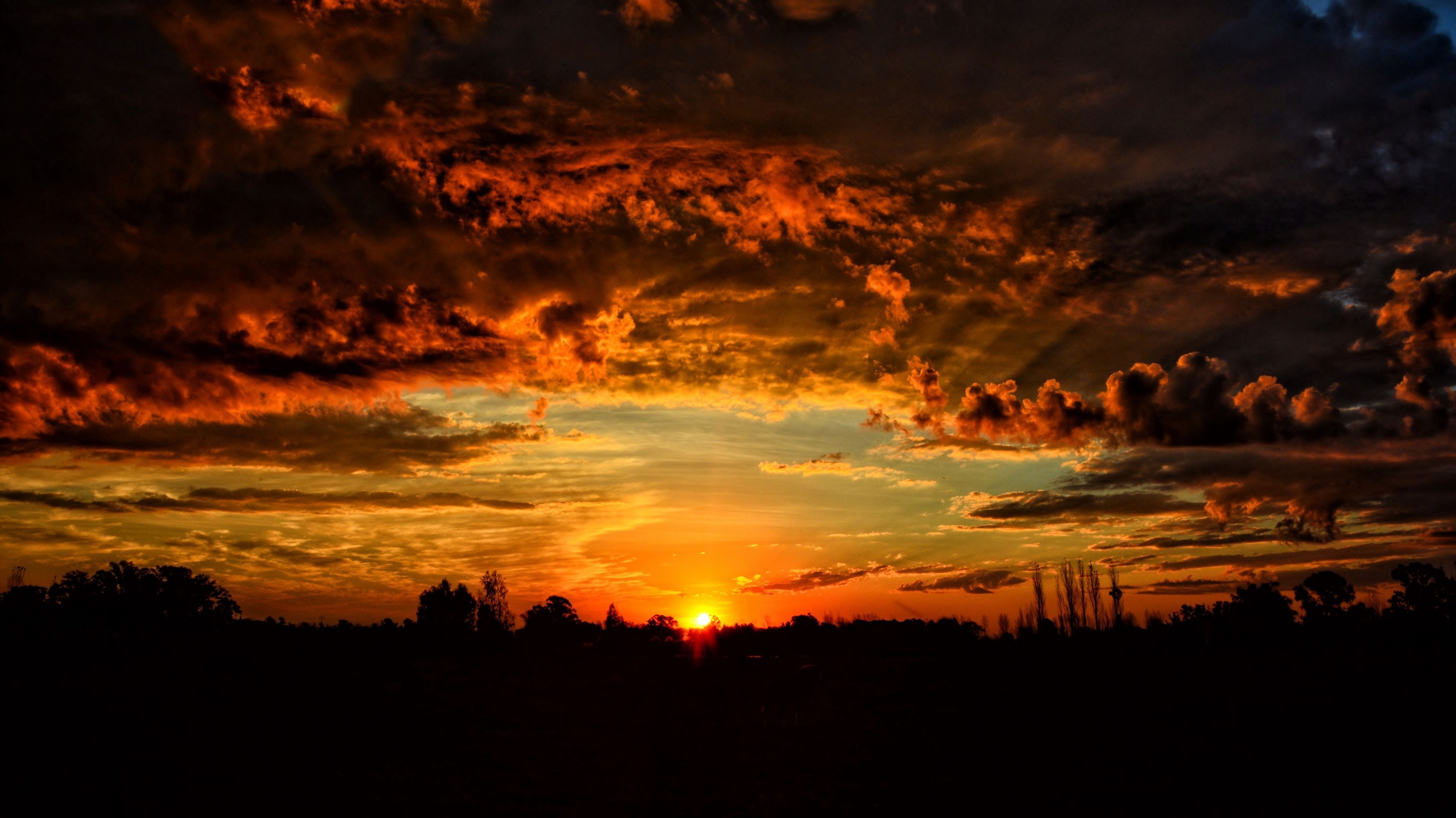 3840x2160 Download wallpaper 3840x2160 sunset, clouds, orange sky 4k uhd 16:9 HD background