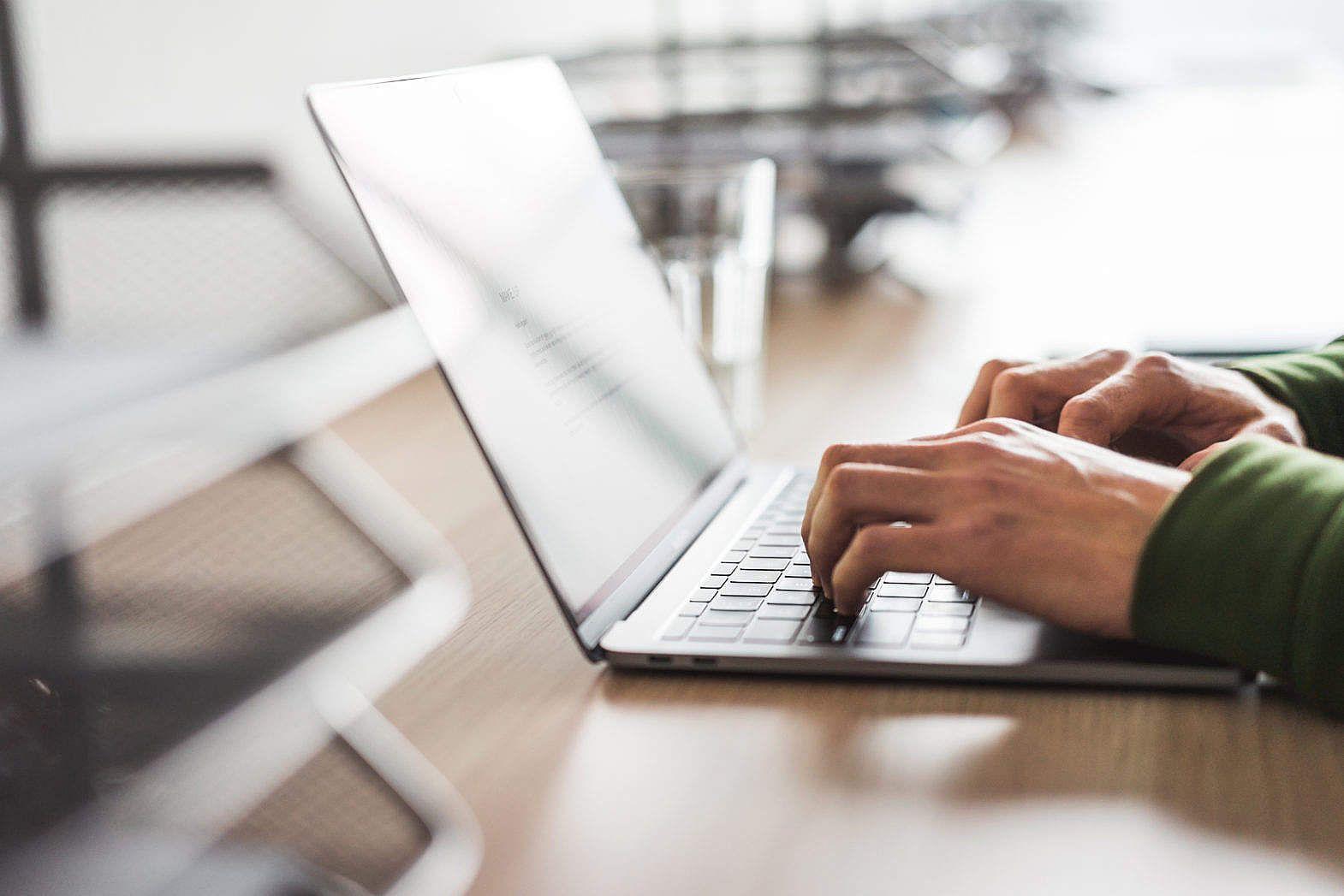 1570x1047 Business Copywriter Typing on His Modern Laptop Free