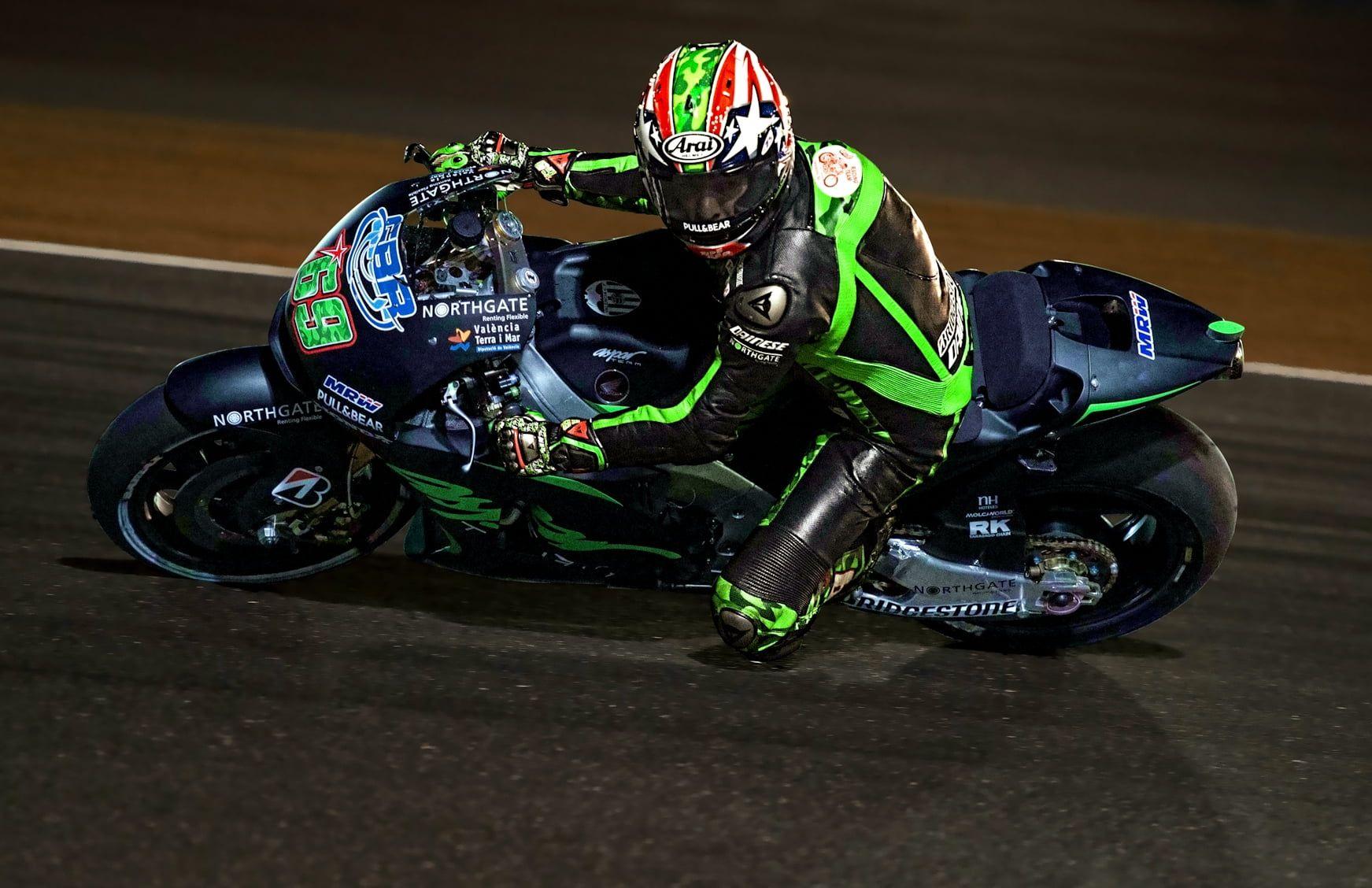 1743x1128 Man wearing racing suit riding sports bike HD wallpaper. Wallpaper