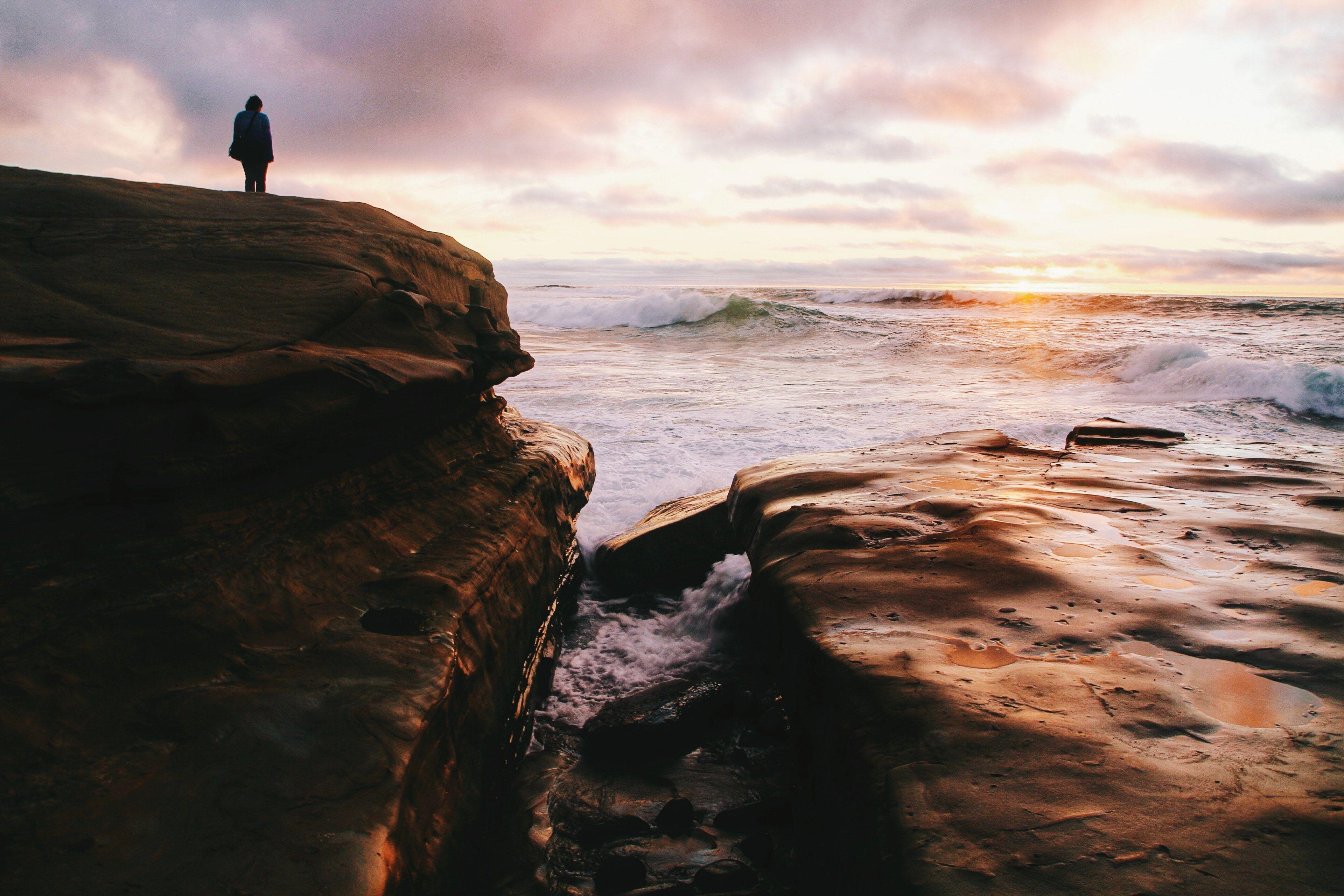 3840x2560 silhouette person standing on coastline rock with white water