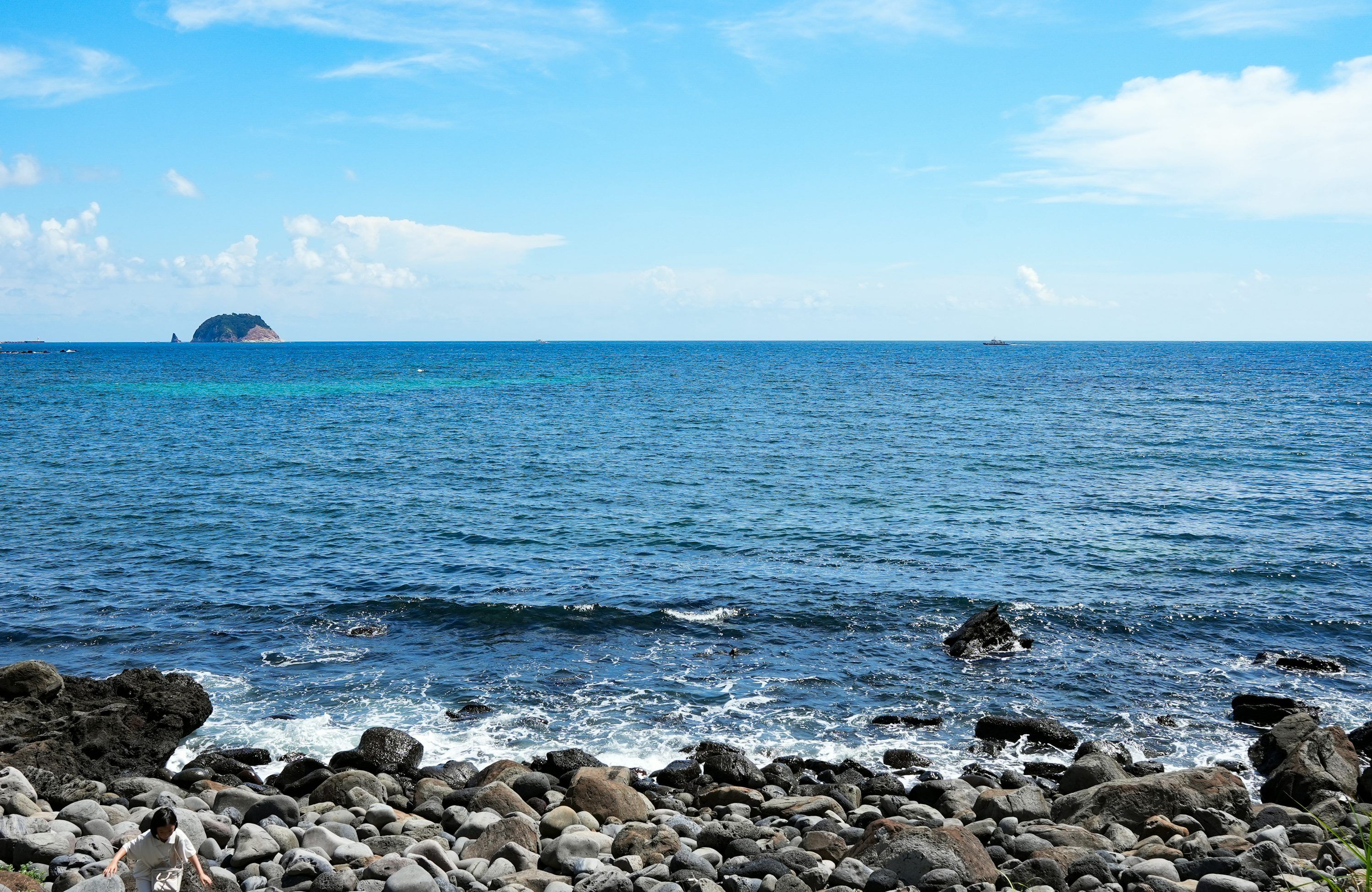 3000x1950 A body of water with land in the back photo