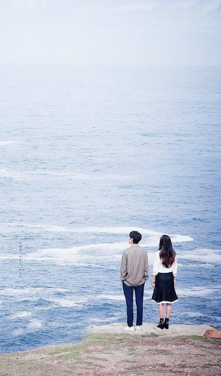 706x1200 Download free Korean Couple Standing Near The Ocean Wallpaper