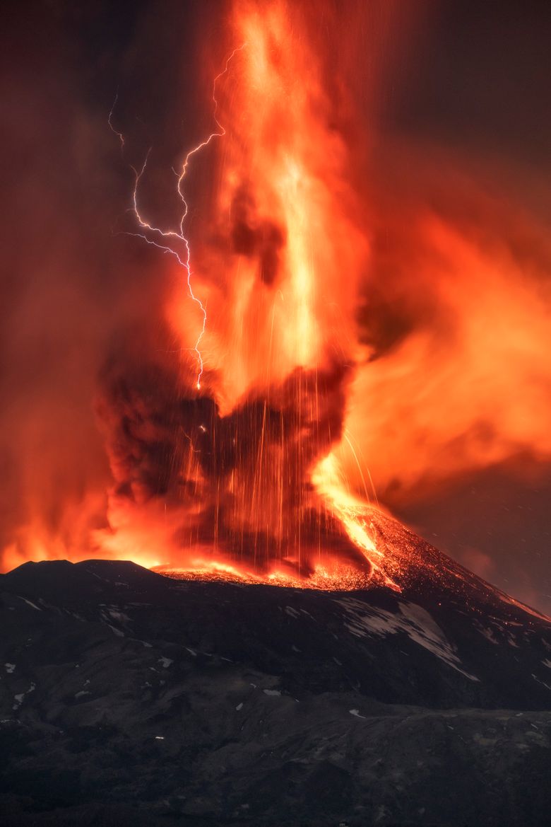 780x1169 Volcanic lightning streaks sky over fiery Mount Etna. The Seattle Times
