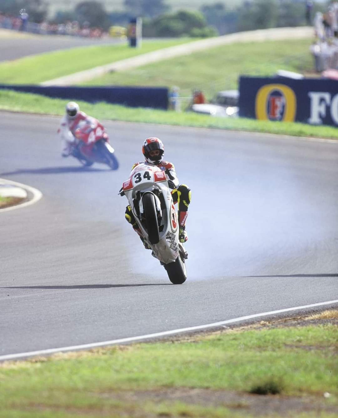 1080x1334 Kevin Schwantz popping a wheelie on the Lucky Strike Suzuki RGV500R, 1993