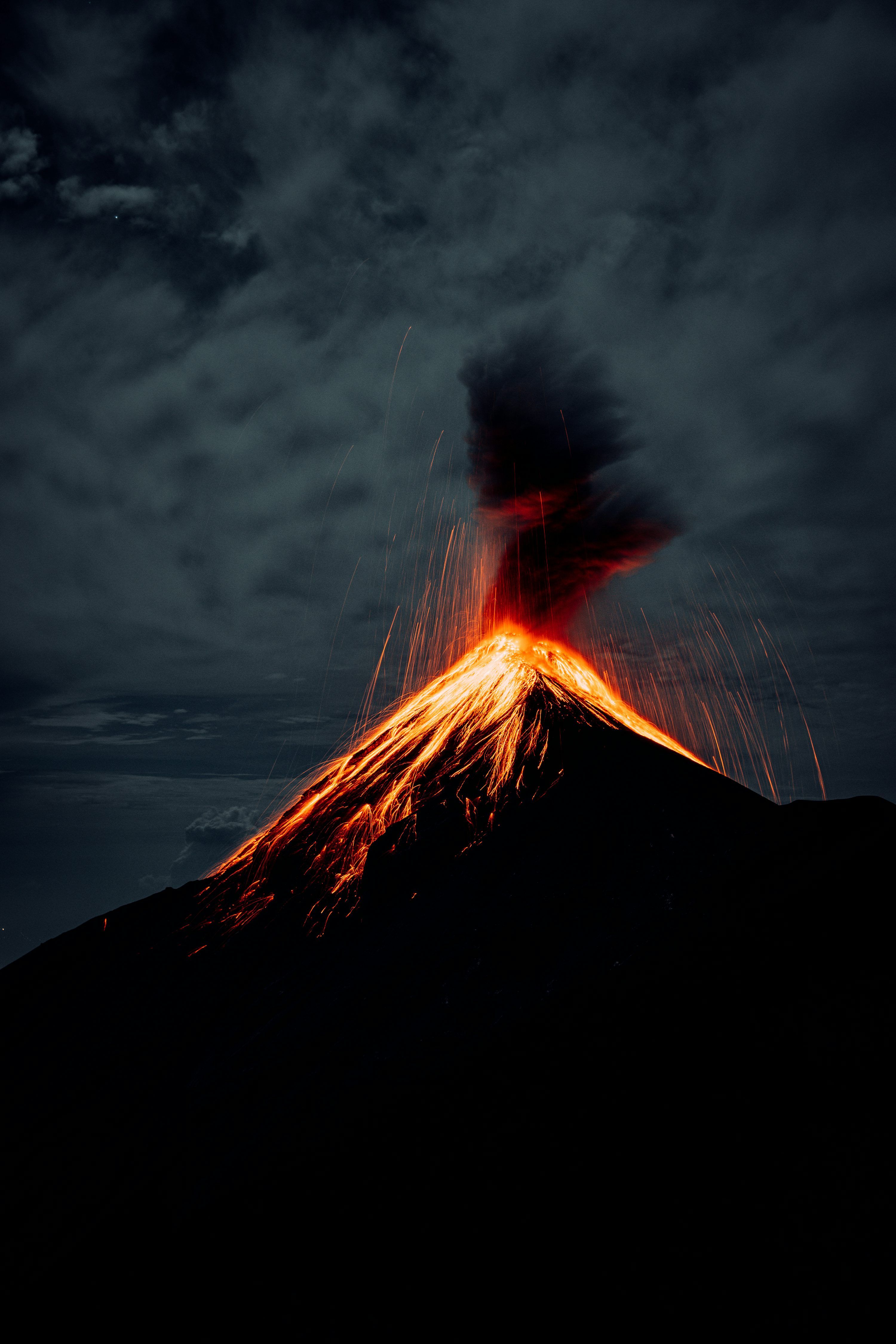 3000x4500 A silhouette of a person with a fire in the background photo