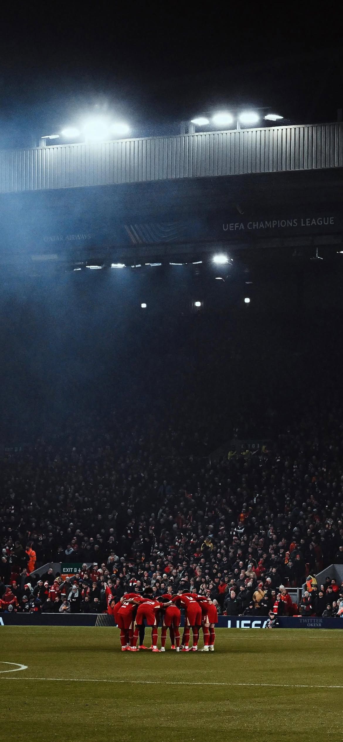 1170x2531 Liverpool FC team huddle at Anfield in UCL match Football Wallpaper