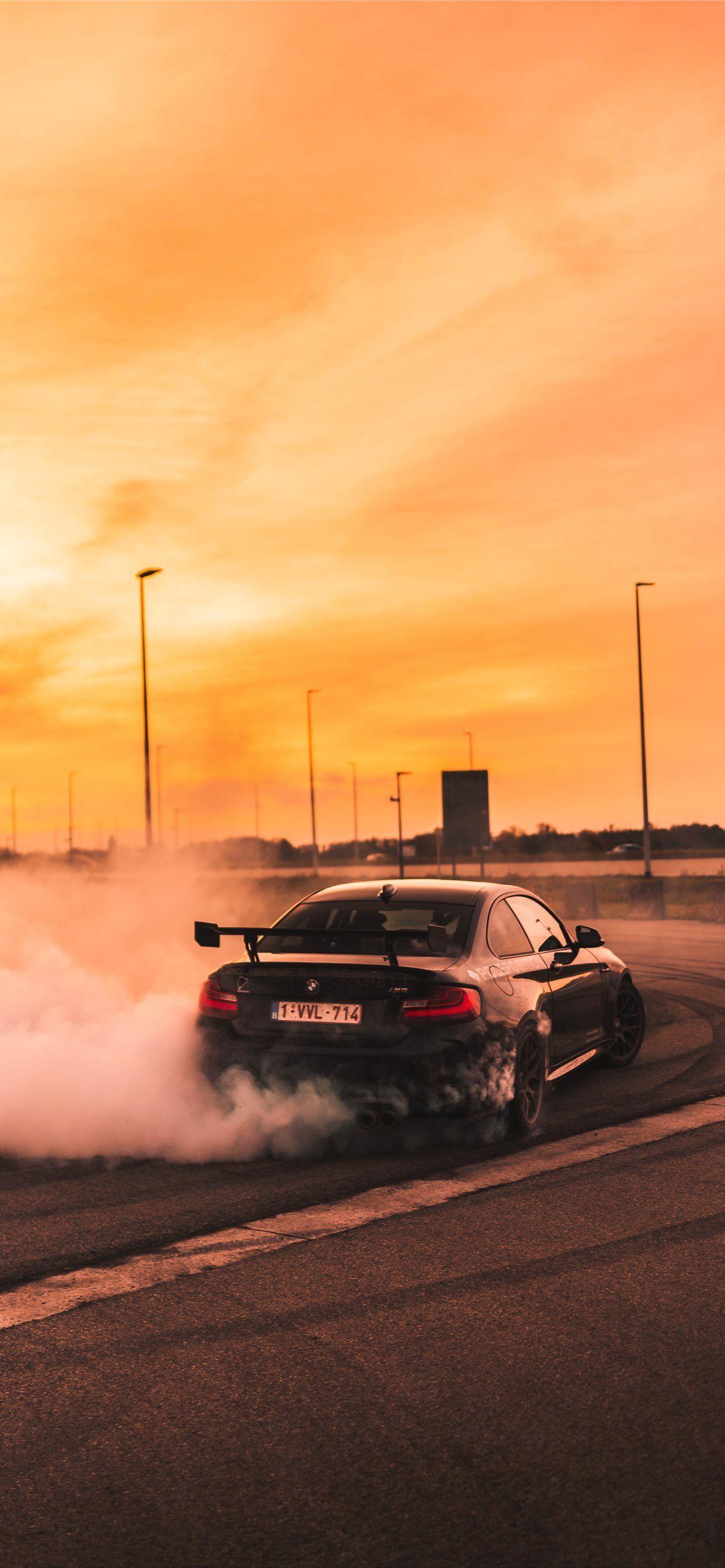 1242x2688 black car drifting on road during day iPhone X Wallpaper Free