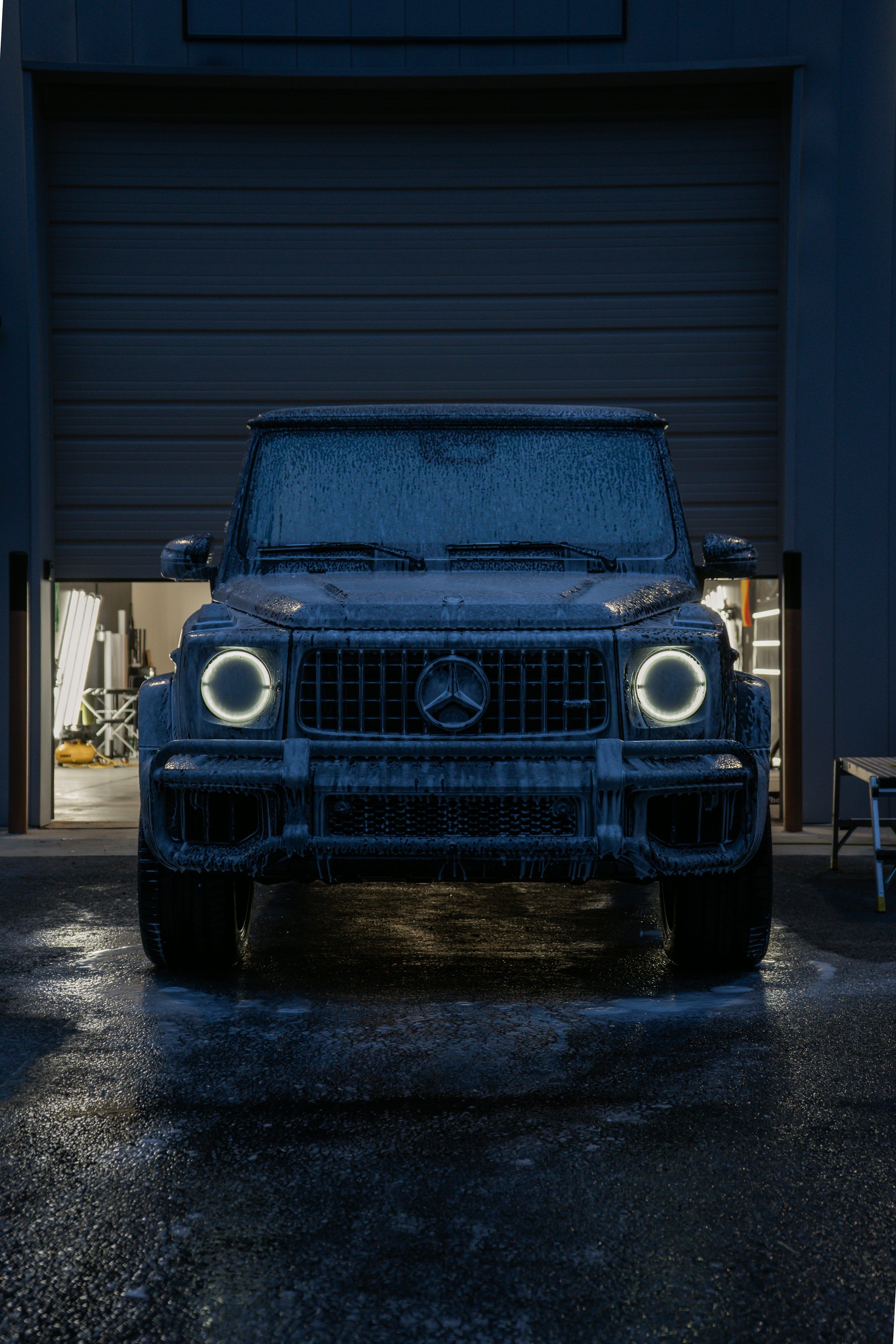 3000x4500 A dark suv with glowing headlights at night. photo