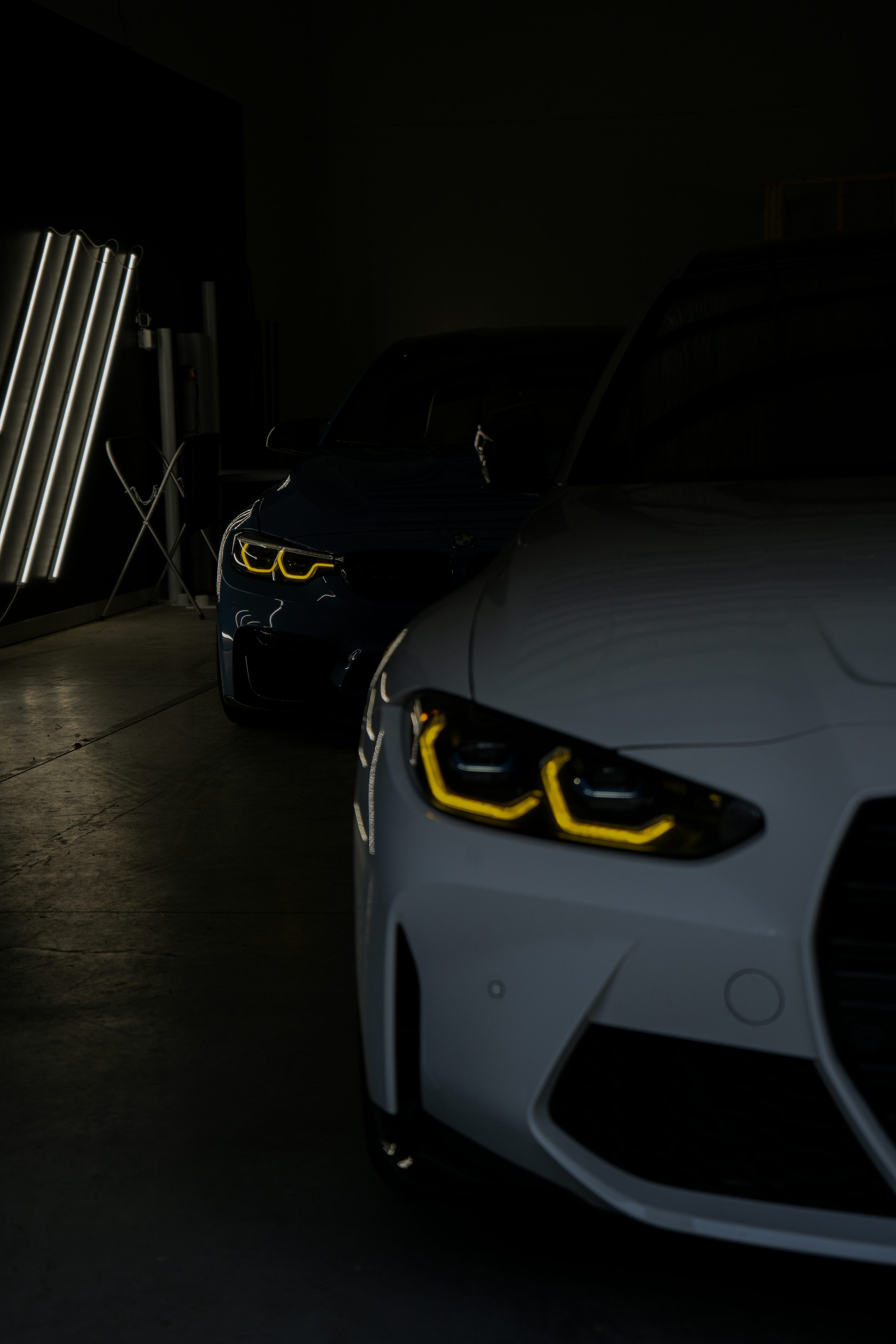 3000x4500 Two modern BMW cars are parked indoors. photo