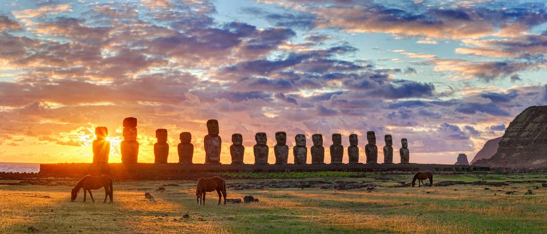 1917x820 easter island chile moai statue horse grass clouds yellow green sea rapa nui Wallpaper HD / Desktop and Mobile Background
