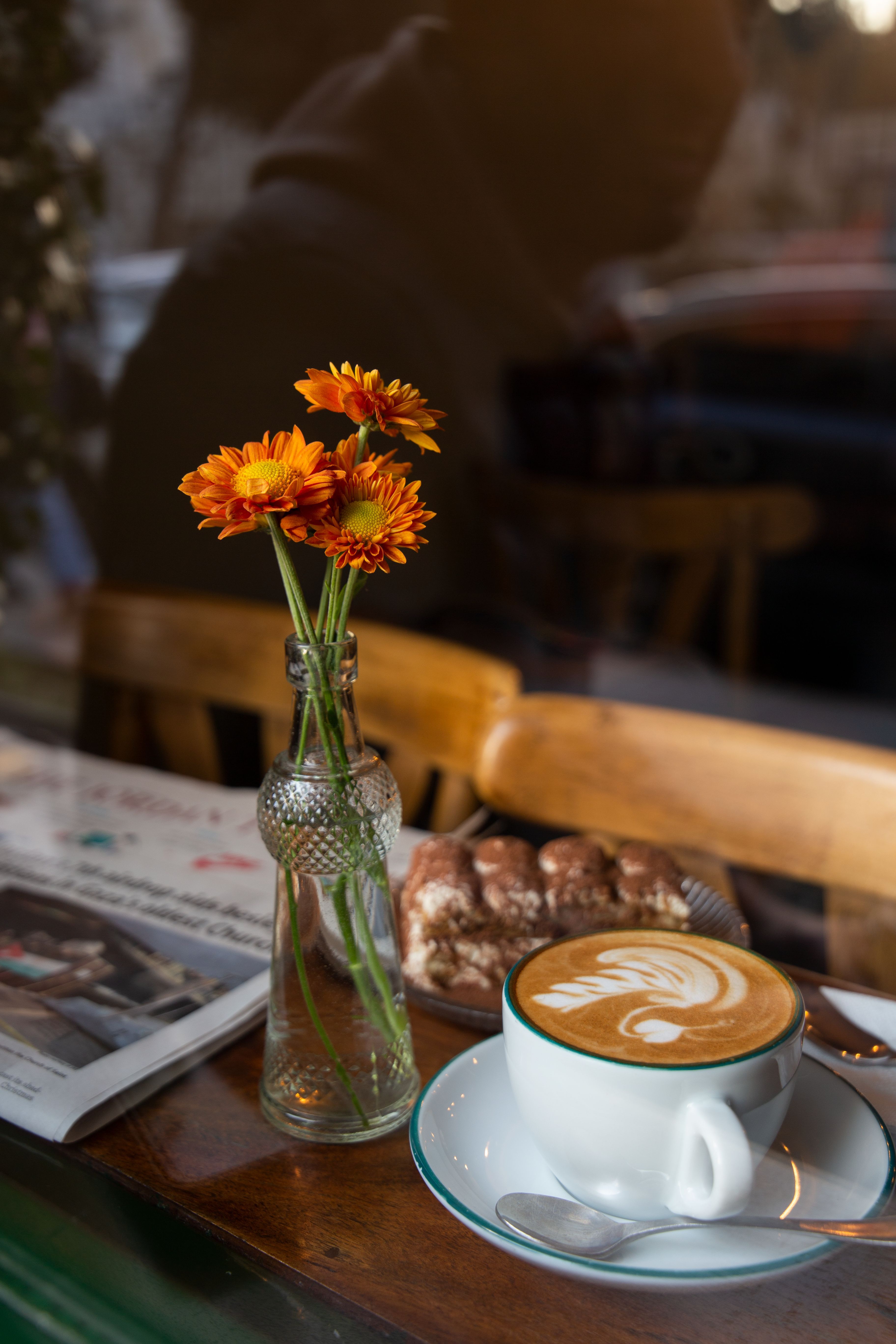 3648x5472 Flowers in Glass Bottle by Coffee Cup on Table in Cafe · Free