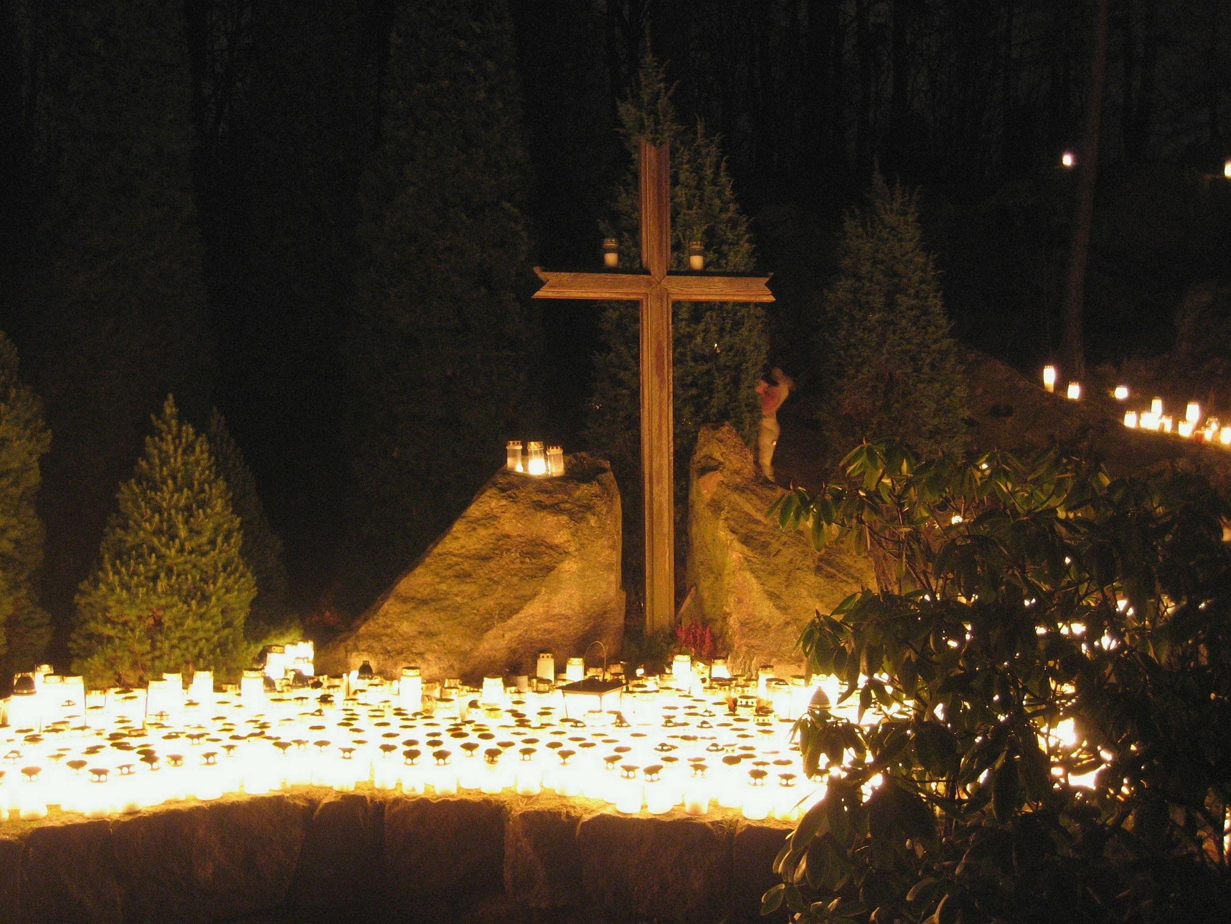 2466x1850 Hundreds of candles and a Christian Cross at a cemetery