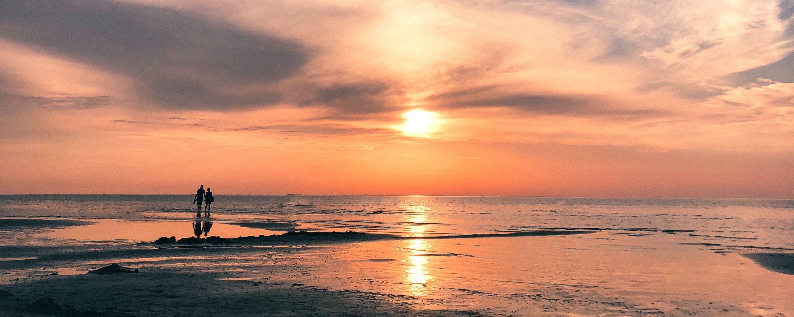 2560x1024 Download wallpaper 2560x1024 beach, sea, sun, sunset, water, sand