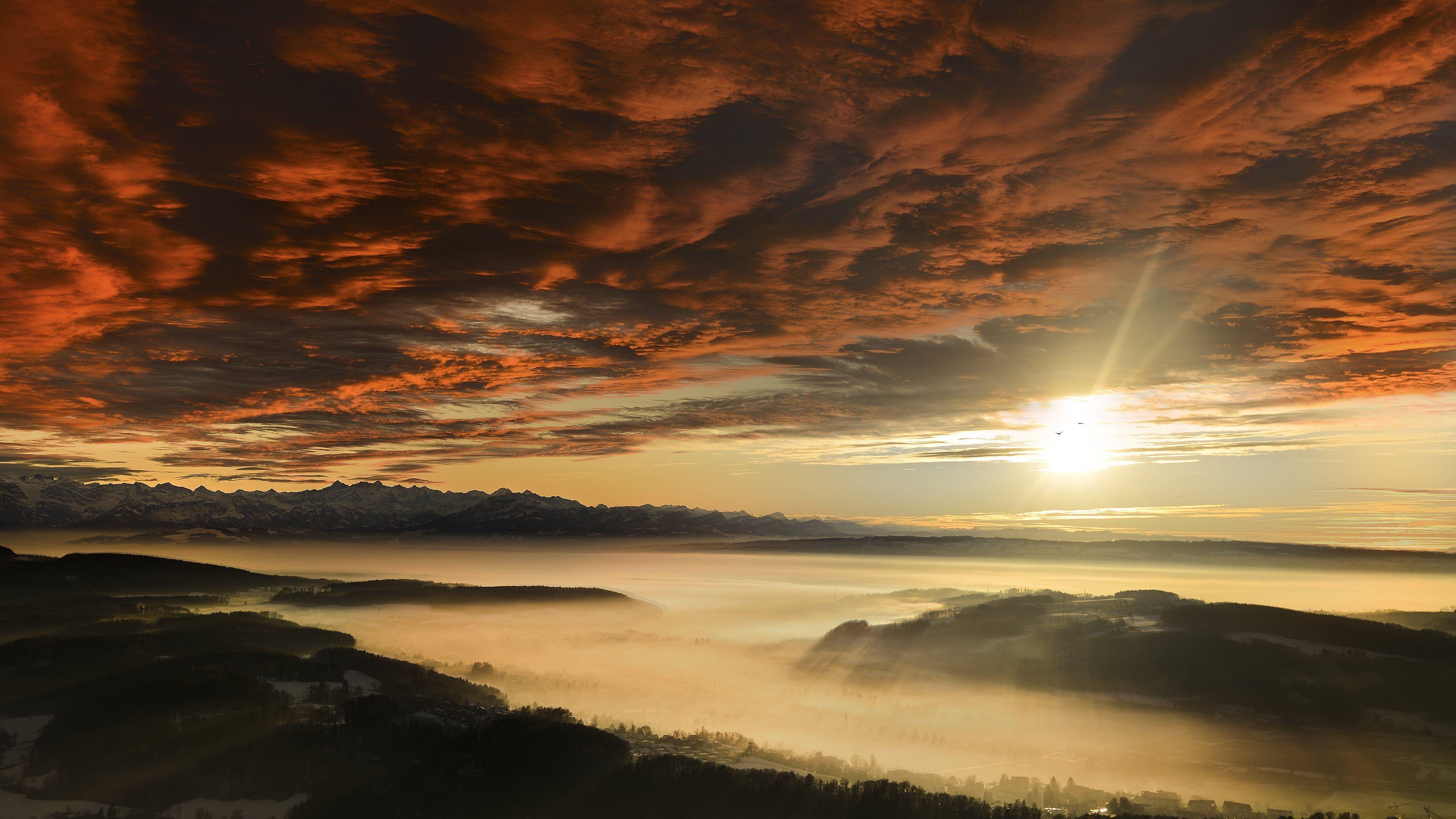 3840x2160 Sunset sunrise clouds fog mountains sun wallpaperx2160