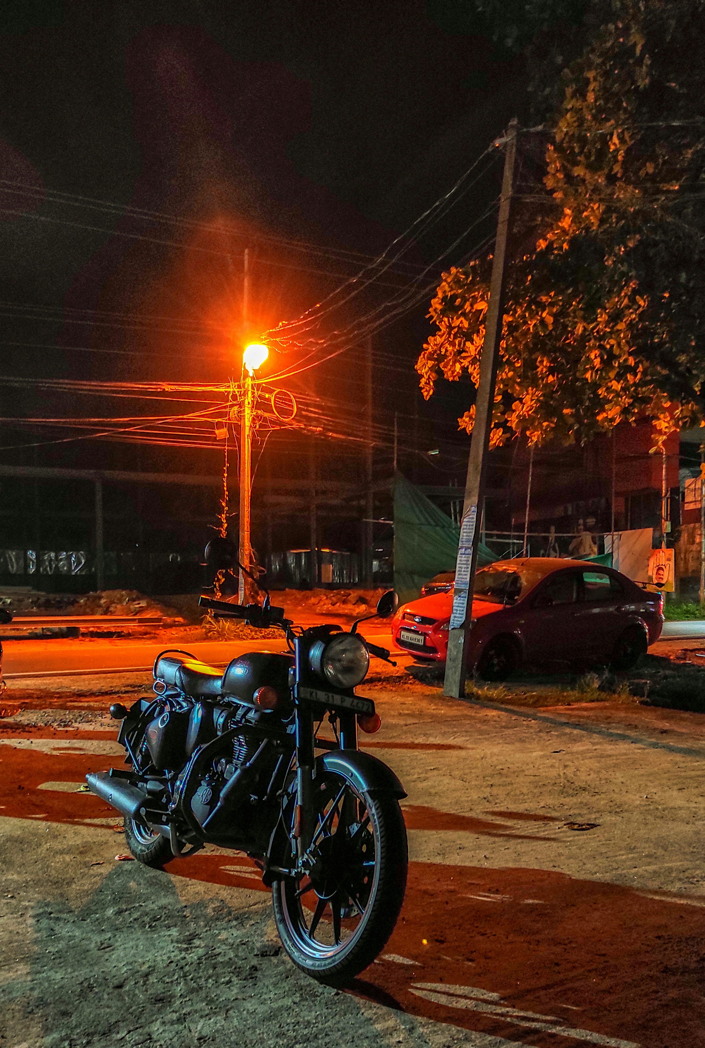3000x4459 Black motorcycle parked on the side of the road during sunset photo