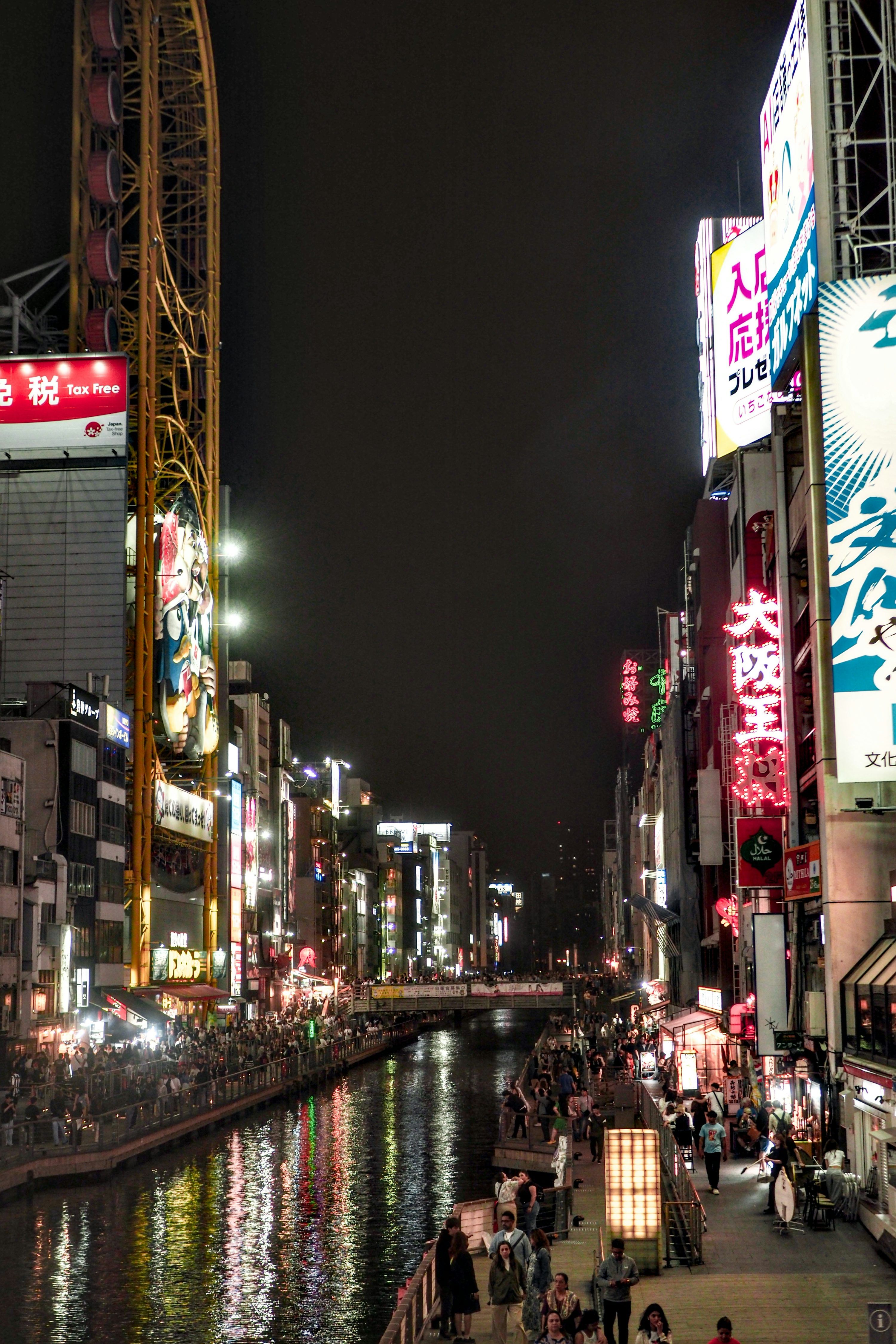 3000x4500 Night view of a bustling city with lights and a river. photo