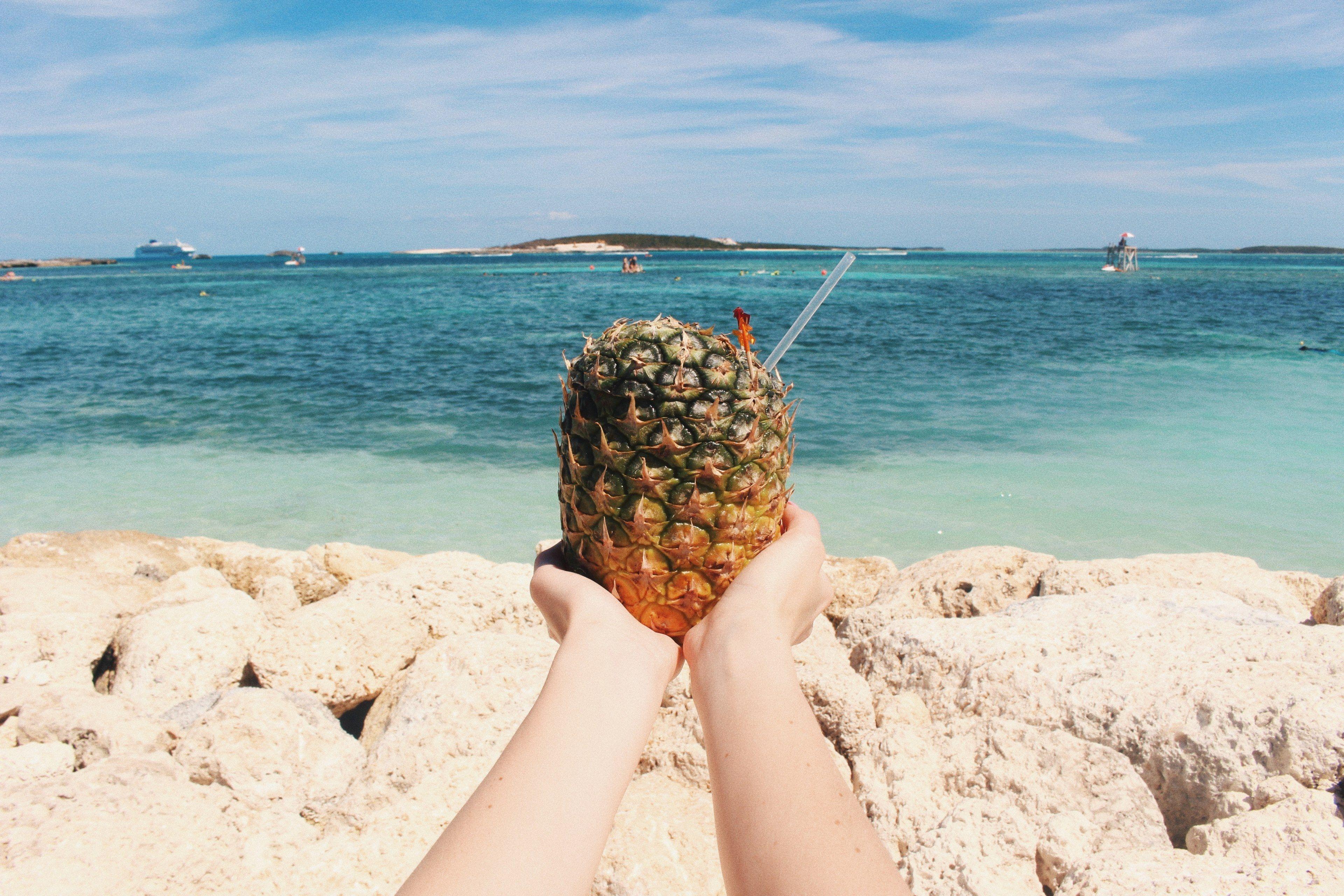 3840x2560 a first person perspective of someone holding a pineapple drink