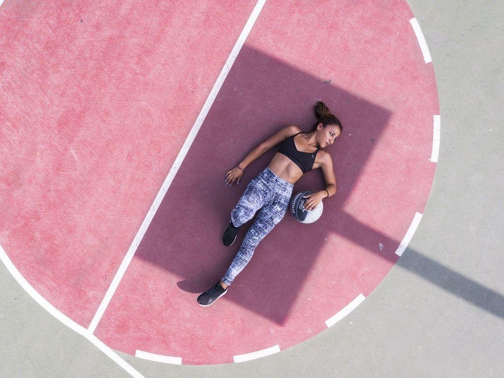 1024x768 Woman Lying on Basketball Court HD Wallpaper
