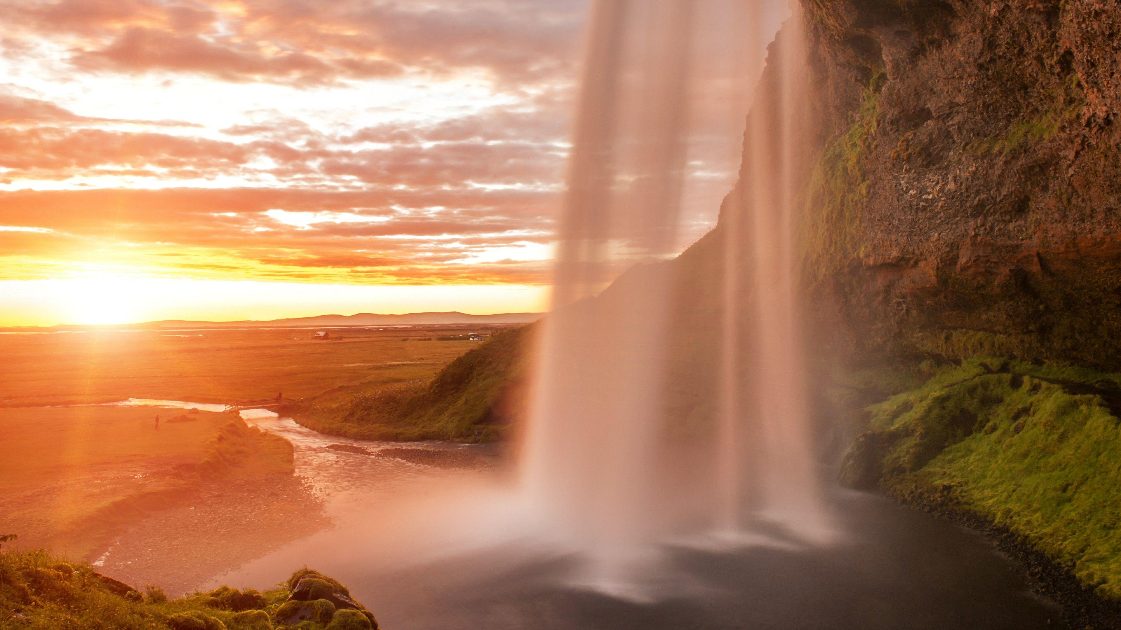 3840x2160 Behind The Seljalandsfoss Waterfall At Midnight Sun Wallpaper