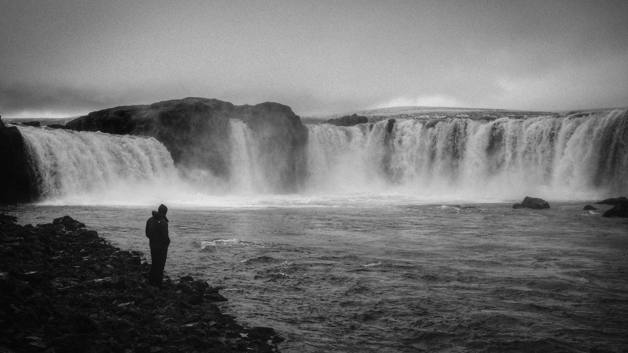 2560x1440 Download wallpaper 2560x1440 man, alone, bw, waterfall, nature
