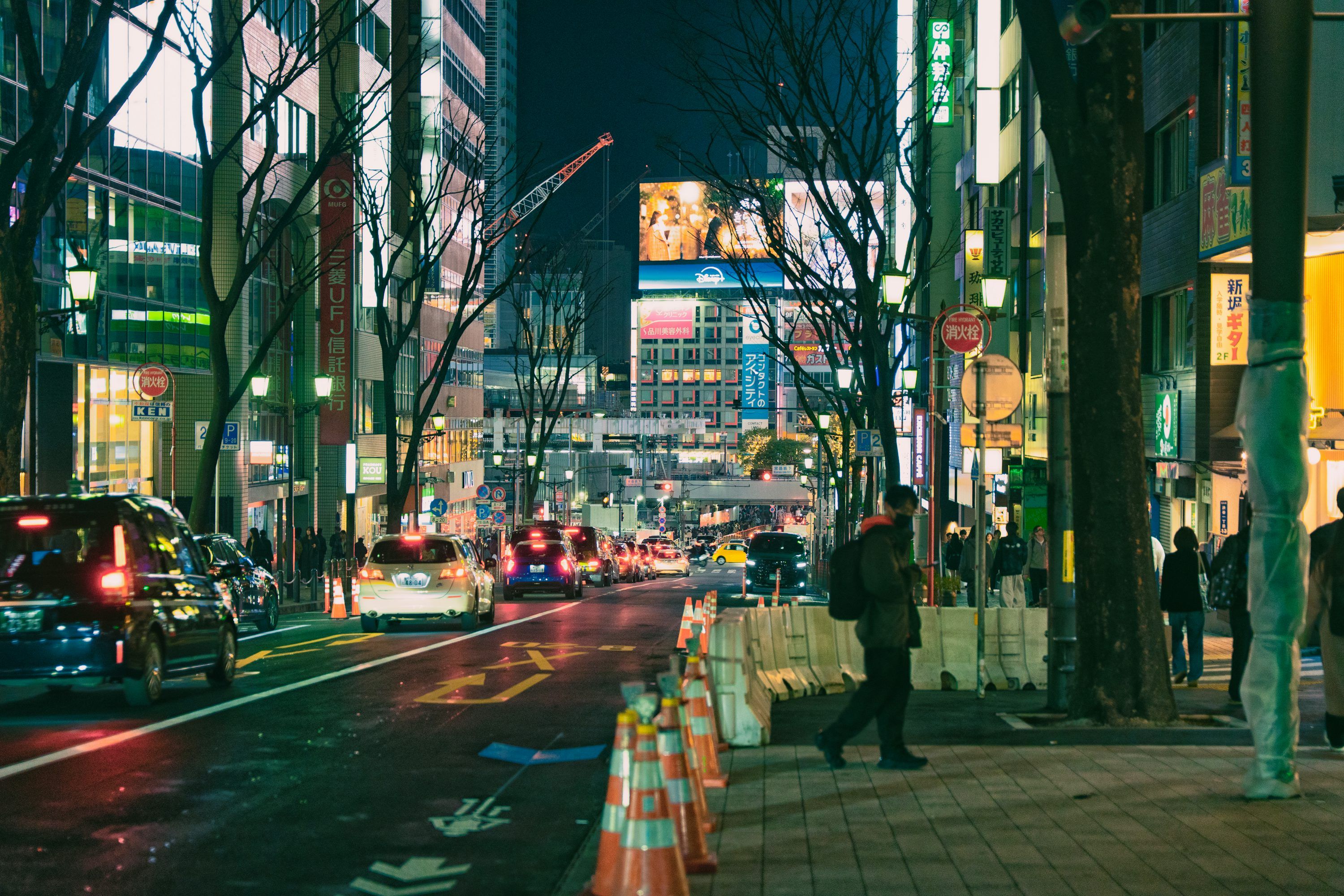 3000x2000 A busy city street at night with neon lights. photo