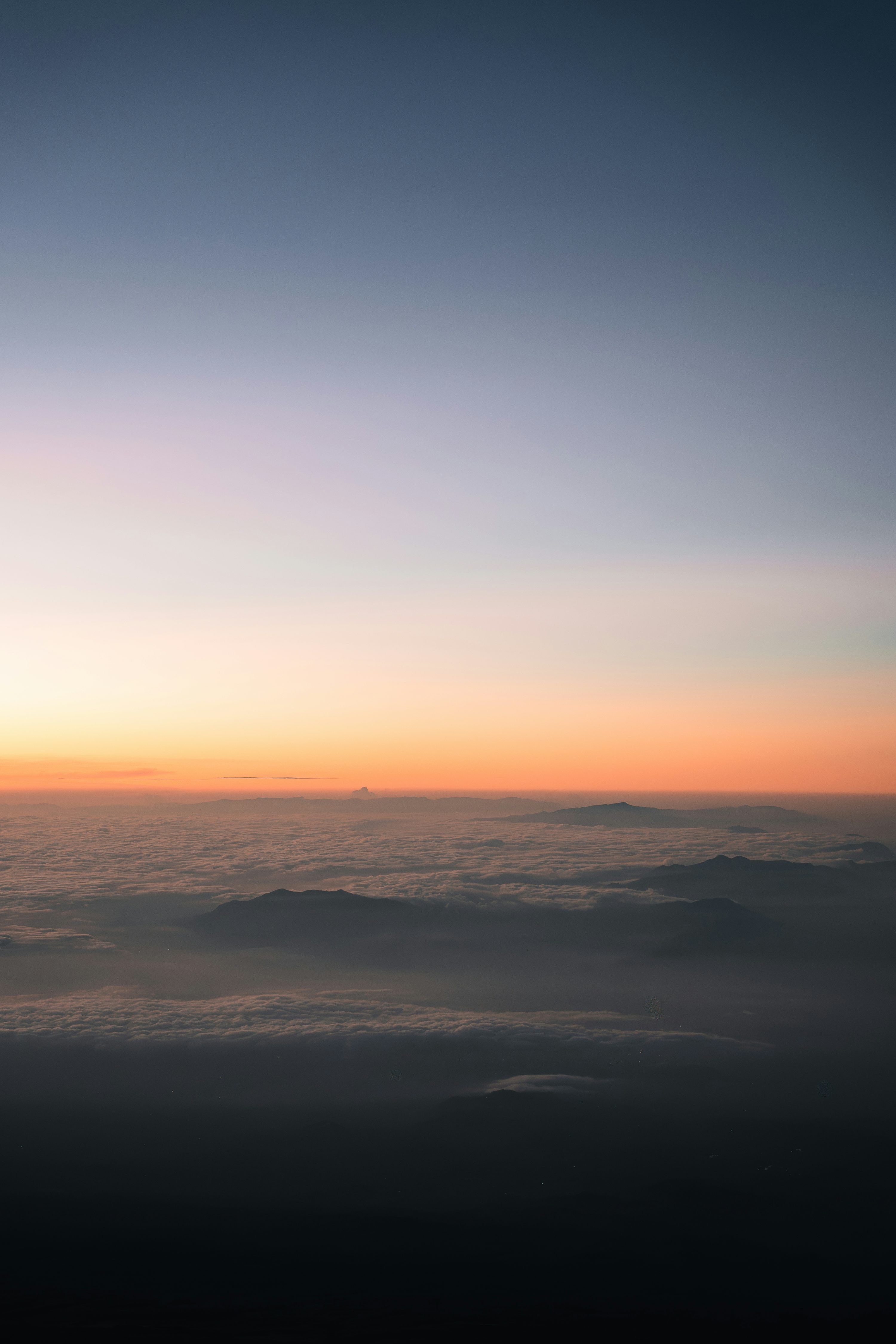 3000x4500 Sunset colors over clouds and mountains. photo