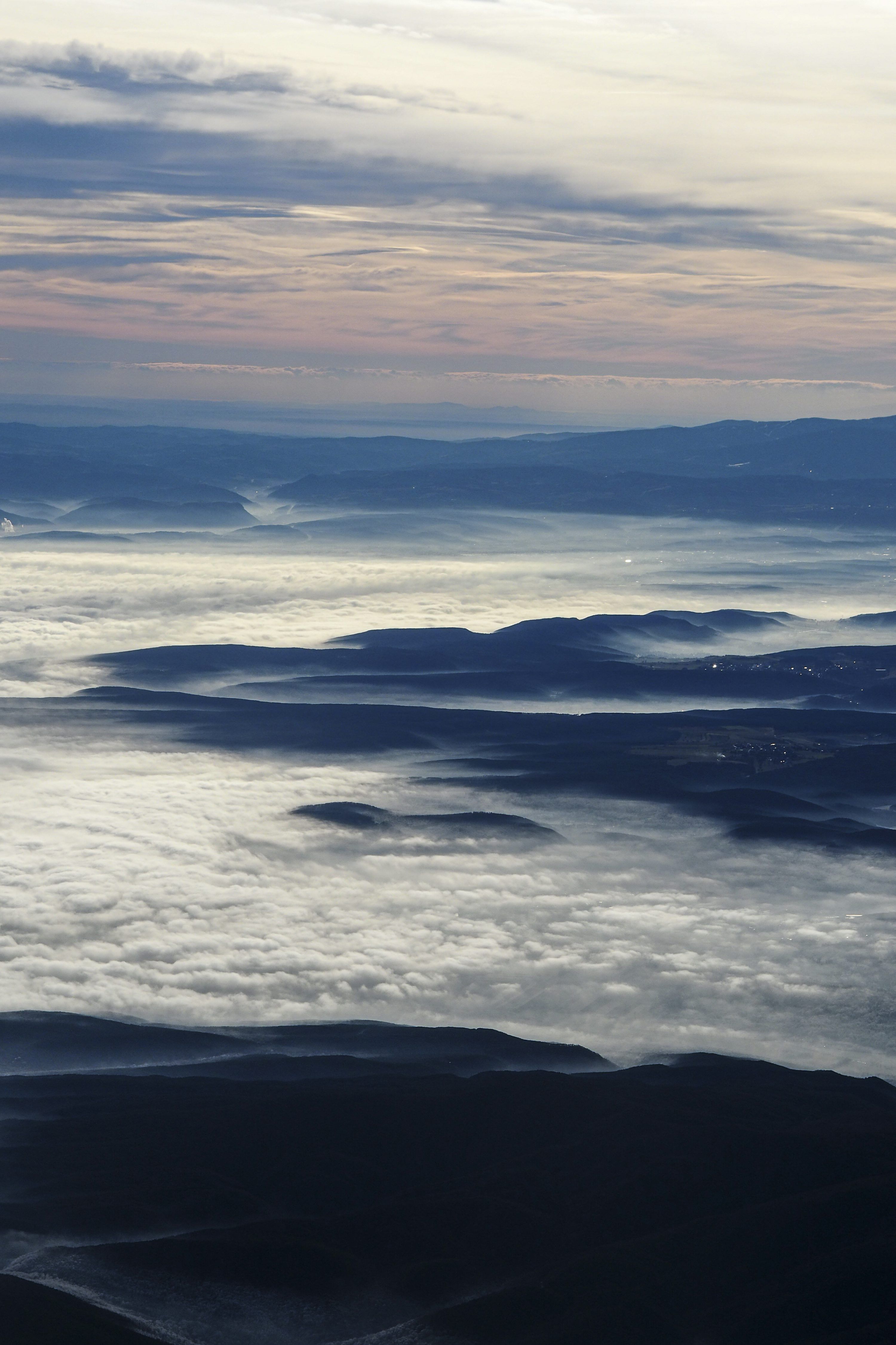 3000x4500 Mountains peak above a sea of clouds at dawn. photo