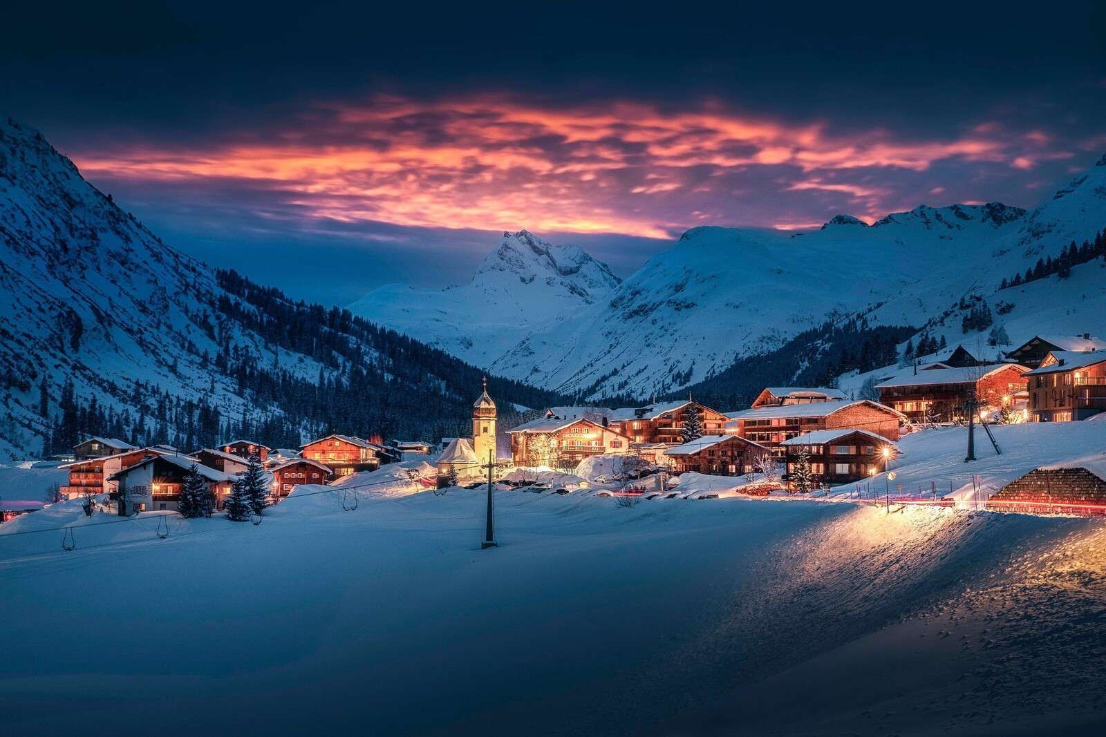 1600x1067 Wall Mural light over mountain village in the snow