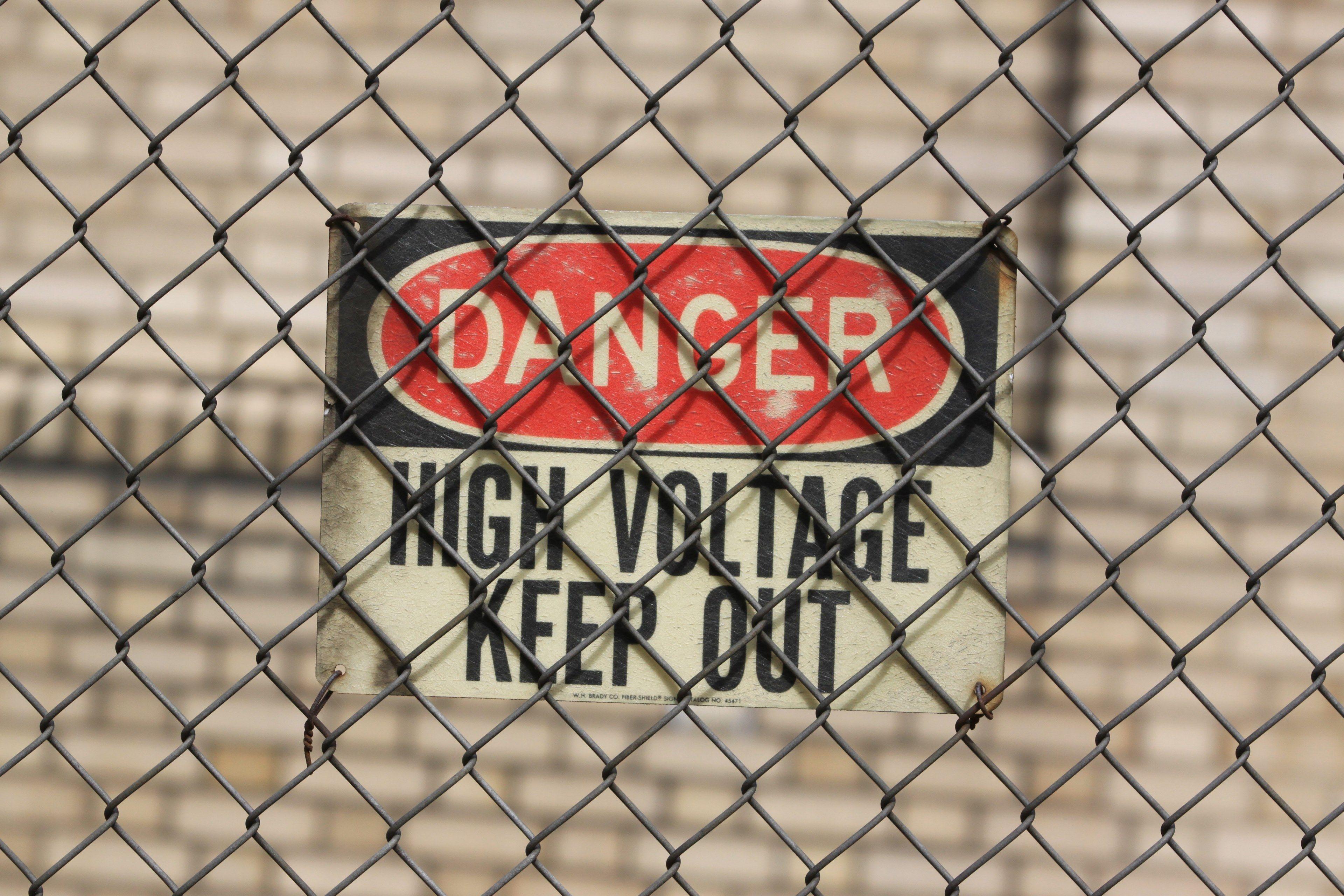 3840x2560 danger sign behind a chainlink fence warns of high voltagehigh