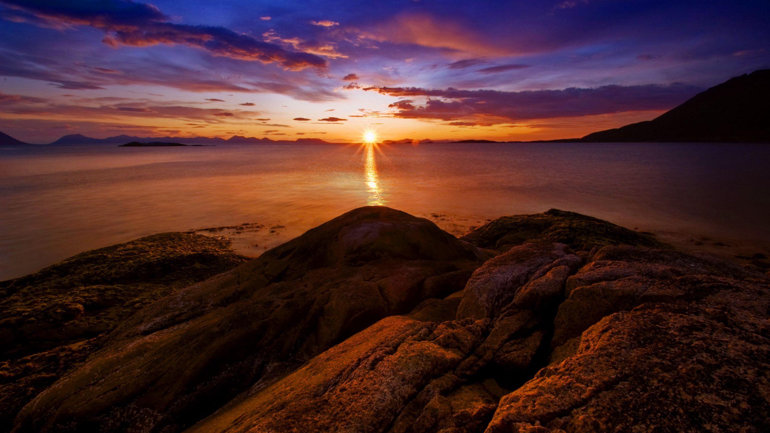 2560x1440 Download wallpaper 2560x1440 rocks, sunset, sea, horizon, norway widescreen 16:9 HD background